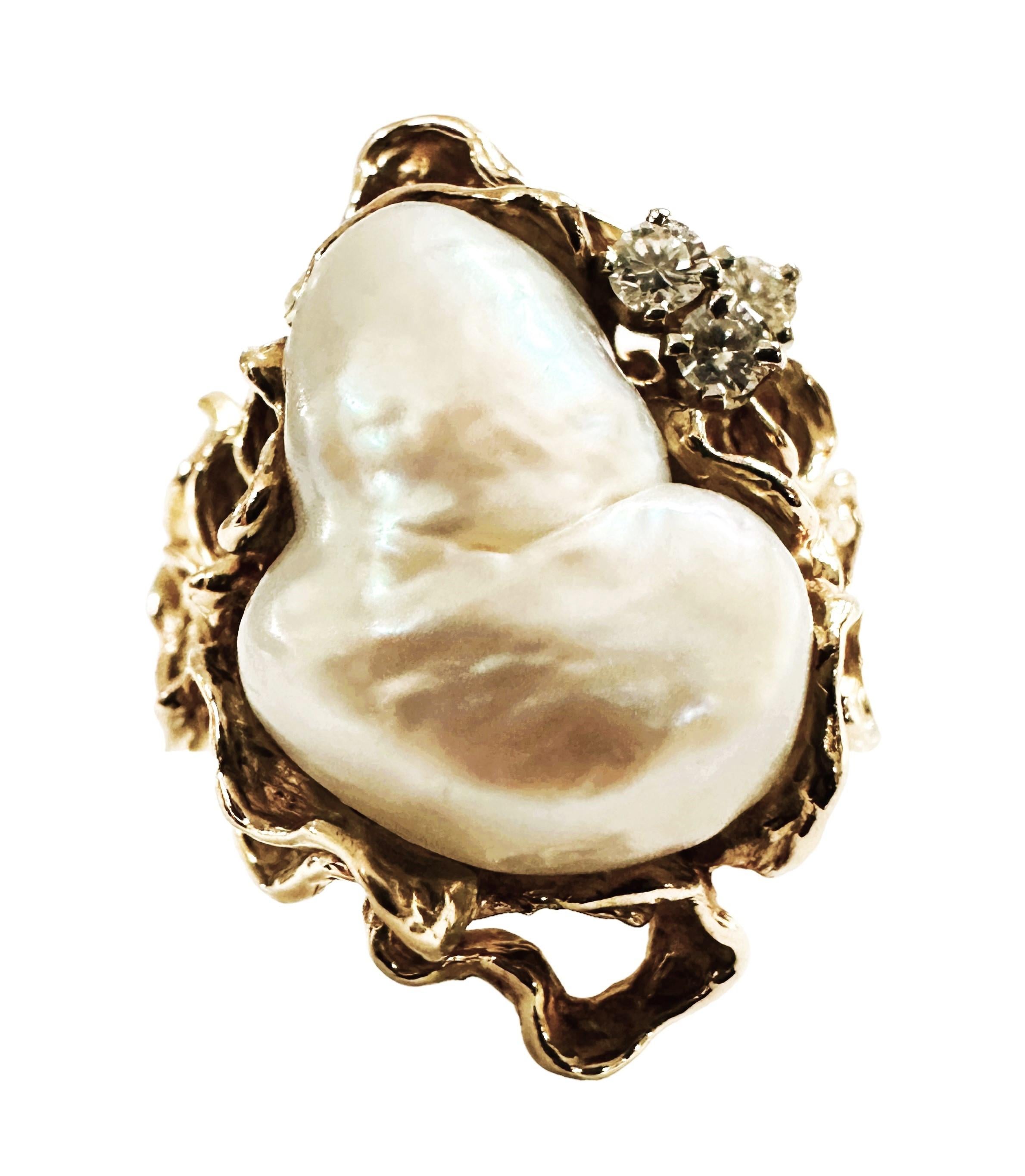 This ring is just gorgeous!  It is a one of a kind design.   It has a large Baroque Pearl centerstone that measures 15.3 x 13.3 mm.  It also has 3 sparking Brilliant Cut Diamond strategically placed next to the pearl.  They measure approximately 2.3