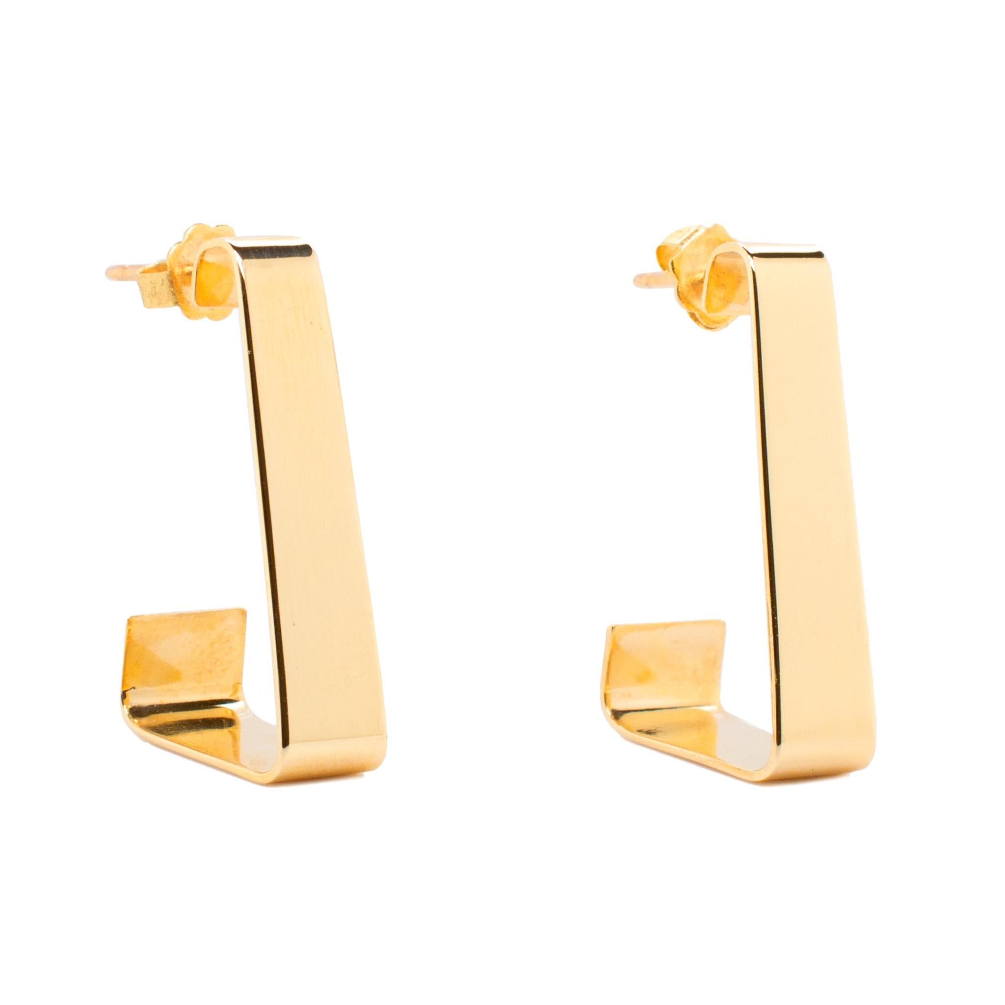 One pair of lady's custom made polished 14K yellow gold, dangle earrings with push backs. The earrings measure approximately 1.25 inches in length by 6.60mm in diameter and weigh a total of 5.80 grams. Engraved with 