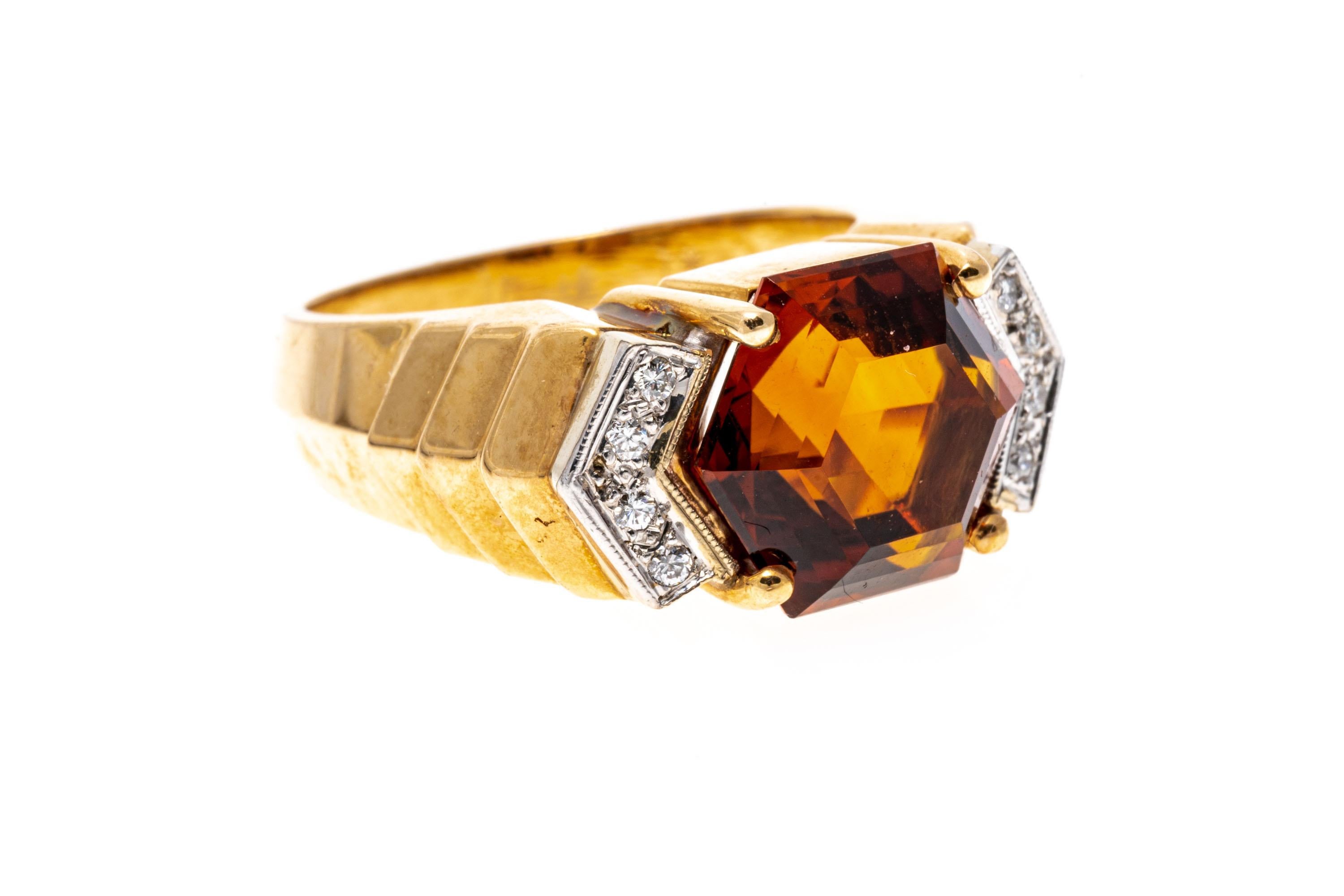 14k yellow gold ring. This chic ring features a center elongated hexagonal faceted, medium to dark orange color citrine, horizontally situated, and flanked by round faceted accent diamonds, approximately 0.08 TCW, prong set. The ring is adorned by a