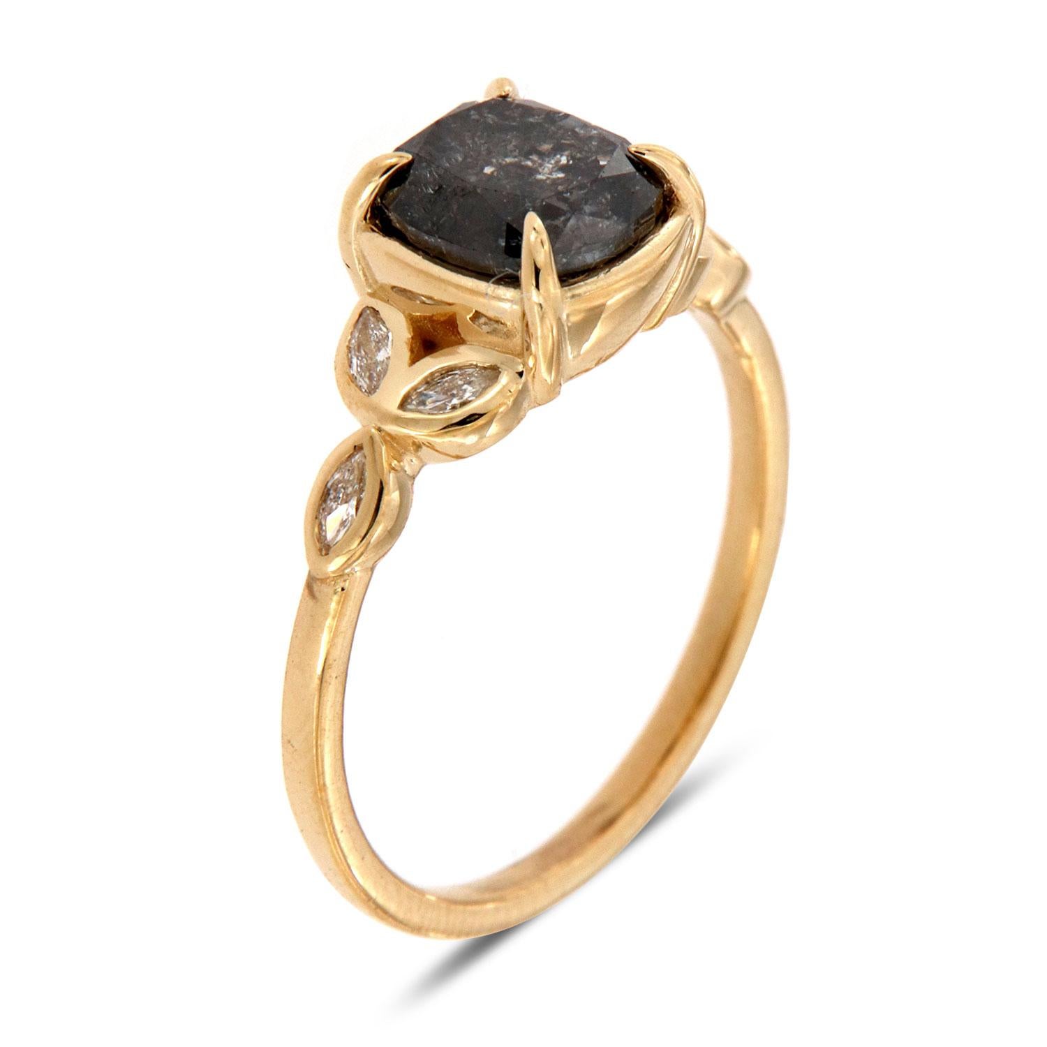 Cette bague au design terreux et organique présente un diamant naturel de 1,85 carat, de forme coussin, de couleur poivre et sel, serti dans quatre (4) griffes et flanqué de six (6) petits diamants de forme marquise, de trois (3) de chaque côté,