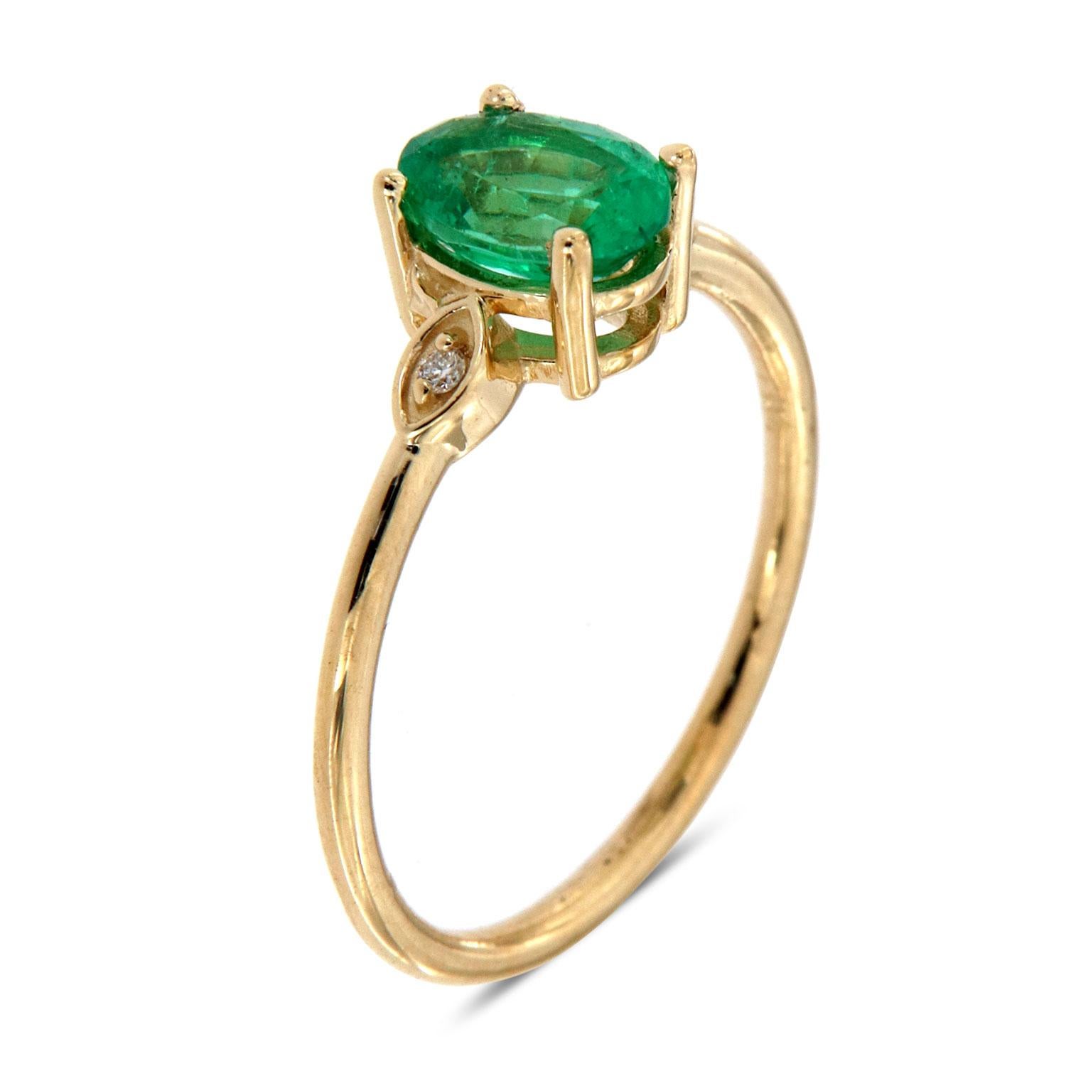 This Delicate Organicly designed ring features a 0.79 Carat Oval Shaped Ethiopian Green Emerald flanked by two round brilliant diamonds in weight of 0.02 Carat set in a Marquise shaped crown. The emerald is sparkling and full of life. Its color is