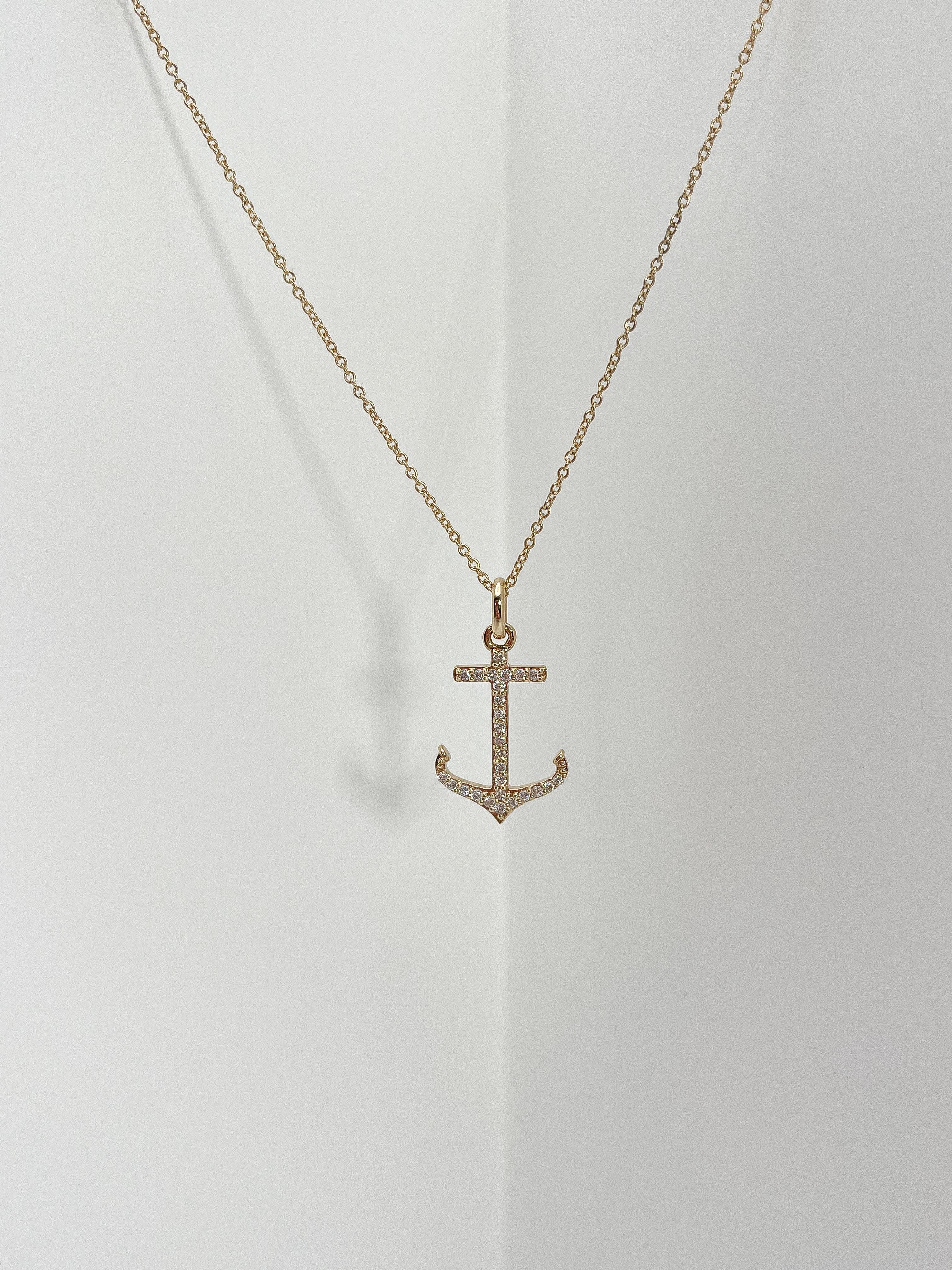 14k yellow gold .25 CTW diamond anchor pendant necklace. All diamonds in the pendant are round, the pendant measures 23mm x 14.5mm, comes on a 16-inch diamond cut cable chain with an extension to 17 inches, has a lobster clasp to open and close, and