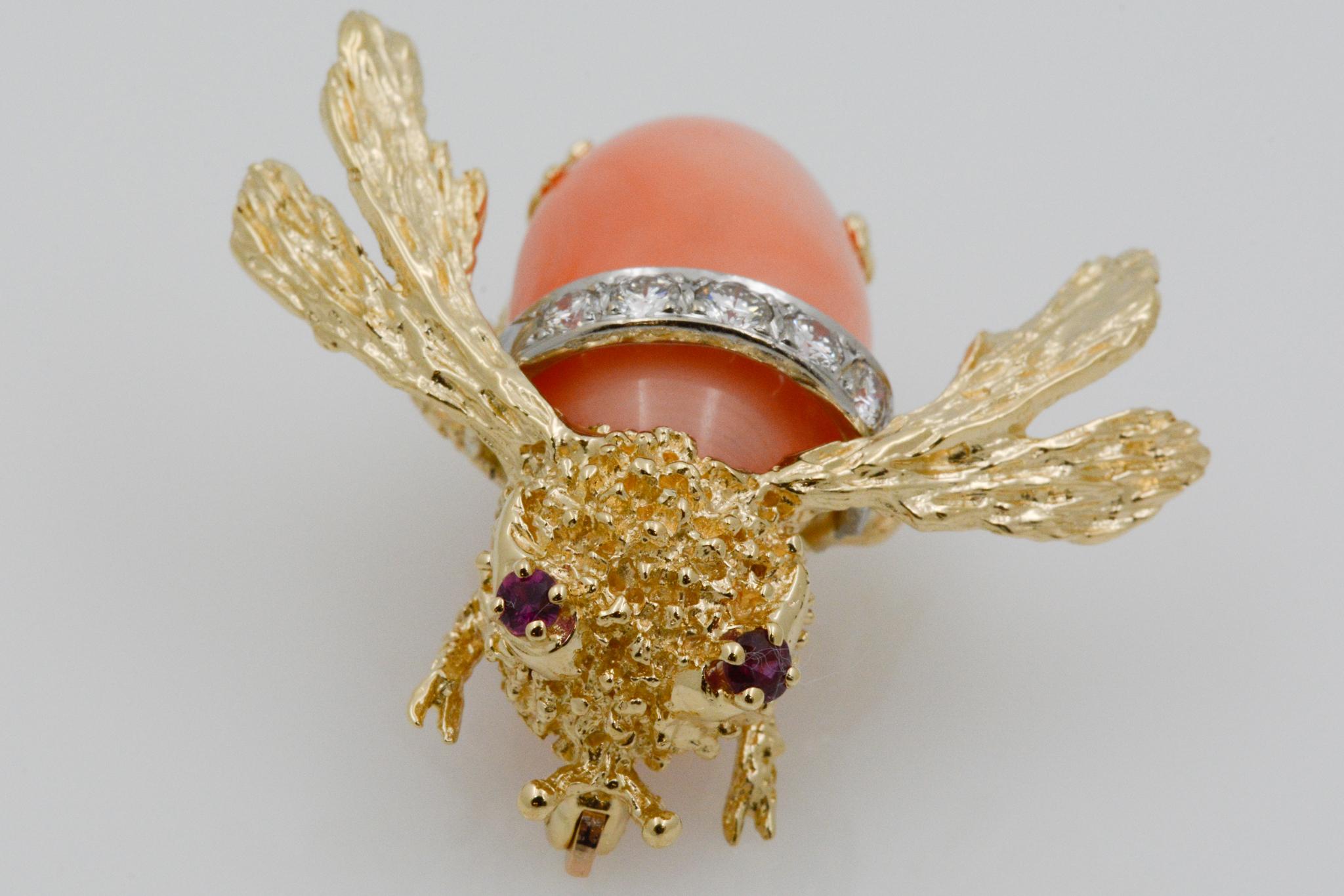 This charming pin features a coral bee with 14k yellow gold wings, two ruby eyes weighing, .10 carats and five round brilliant diamonds weighing, .25 carats H-I SI on the bee's back. The coral body of the bee measures at 21.84x12.28mm. 
