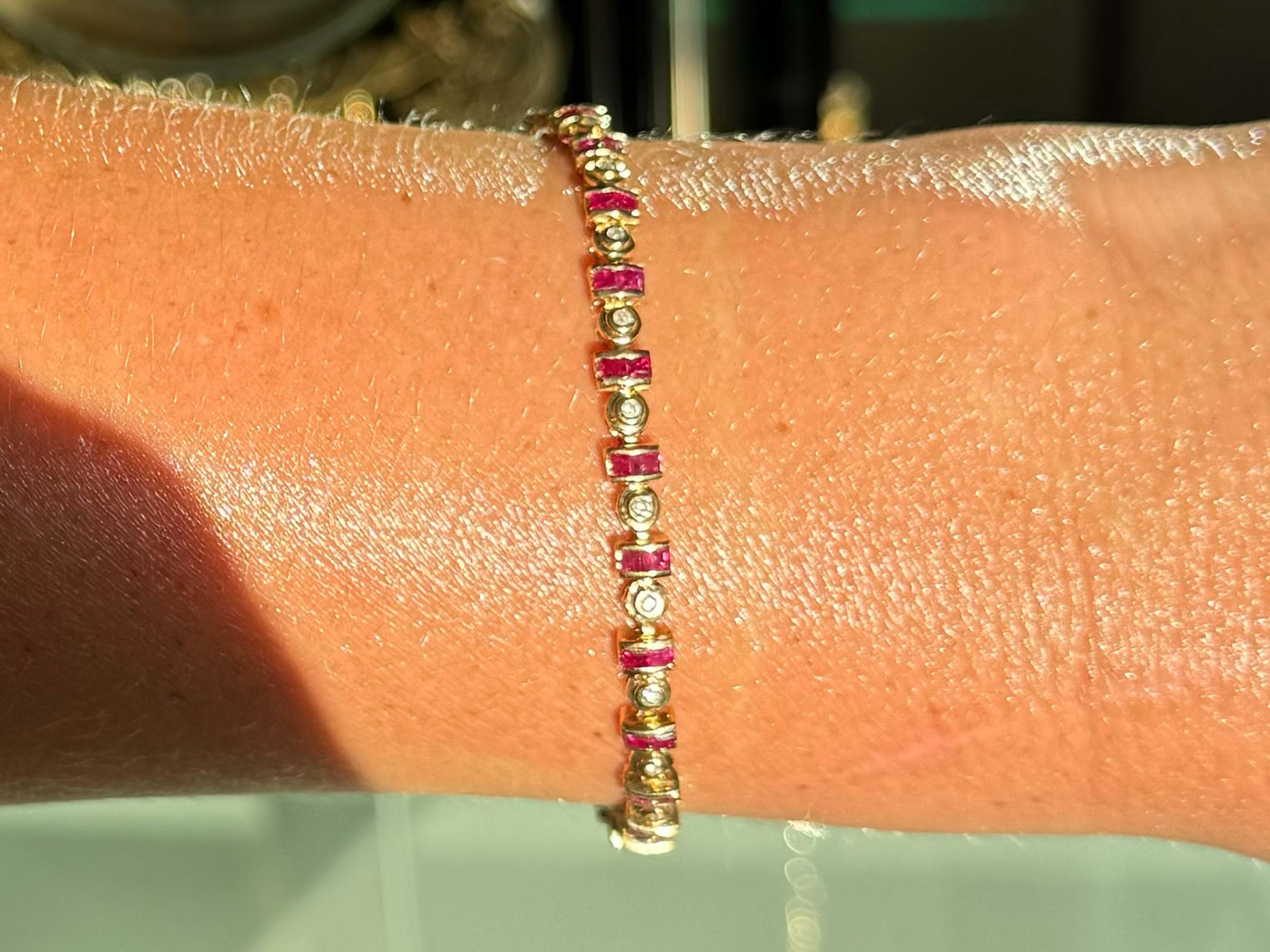 Bracelet Specifications:

Metal: 14k Yellow Gold

Ruby Count: 48 square cut rubies

Ruby Carat Weight: ~2.40 carats

Diamond Carat Weight: ~ 0.25 carats

Diamond Count: 25 brilliant 

Diamond Color: H-I

Diamond Clarity: SI2-I1

Bracelet Length: