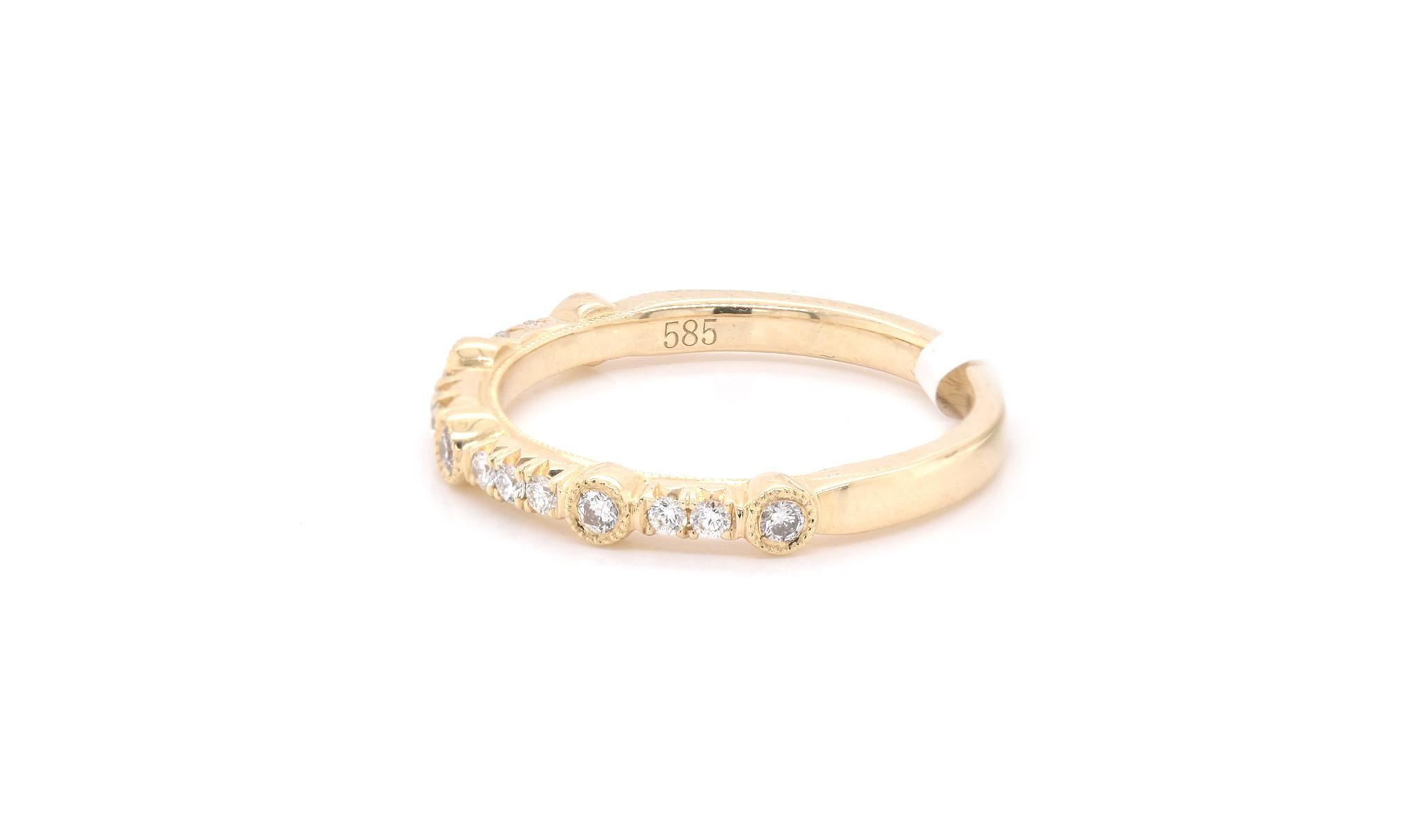 Designer: custom 
Material: 14k yellow gold
Diamond: 15 round brilliant cuts = 0.22cttw
Color: G 
Clarity: VS
Ring Size: 6
Dimensions: ring is 2.65mm wide
Weight: 2.48 grams