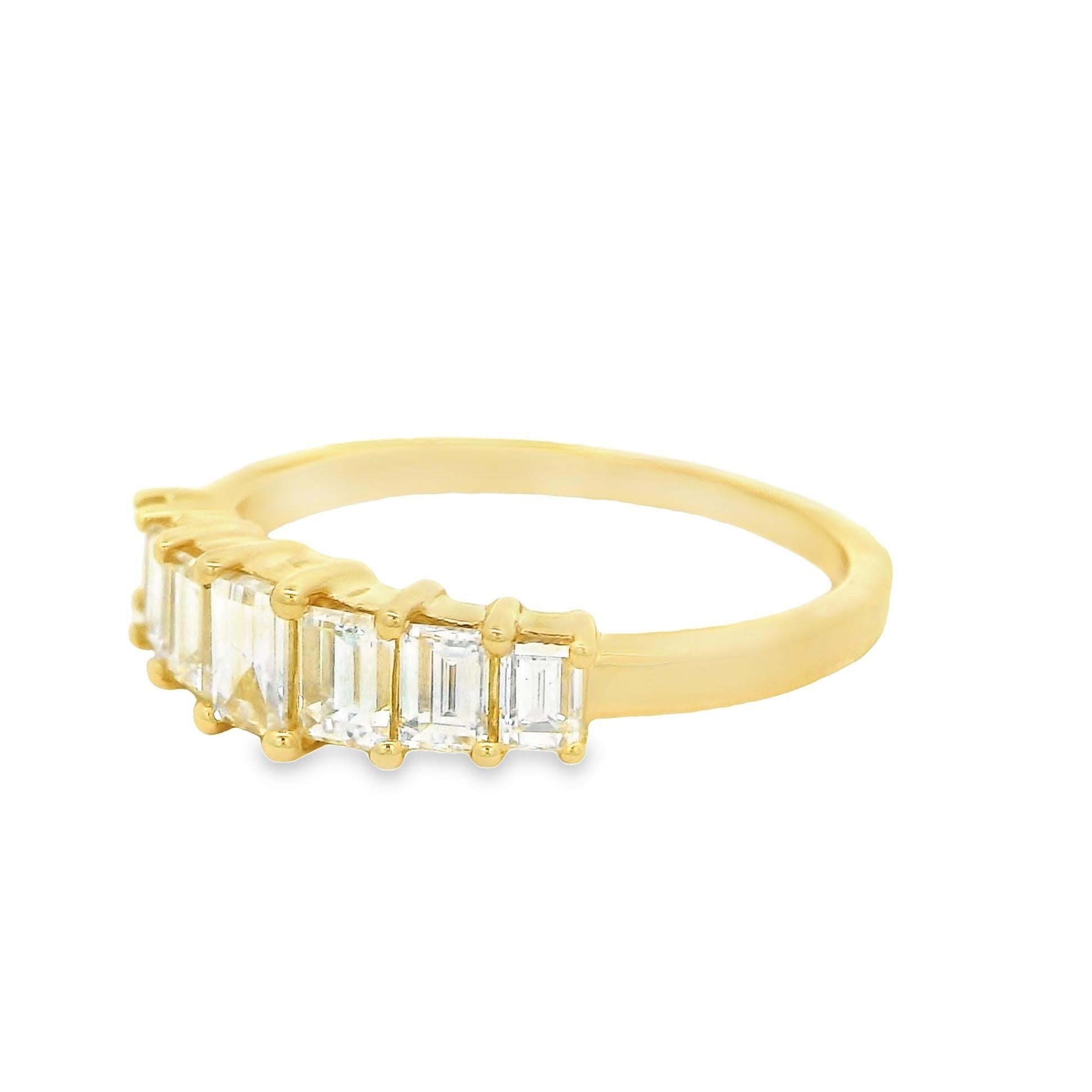 This simple 14k yellow gold band is a perfect piece to have as an everyday wear. Set with a total of 1.08 carats of baguette-cut diamonds which graduate in size from side to side. A perfect choice for a gift or to be worn for any occasion. Made in