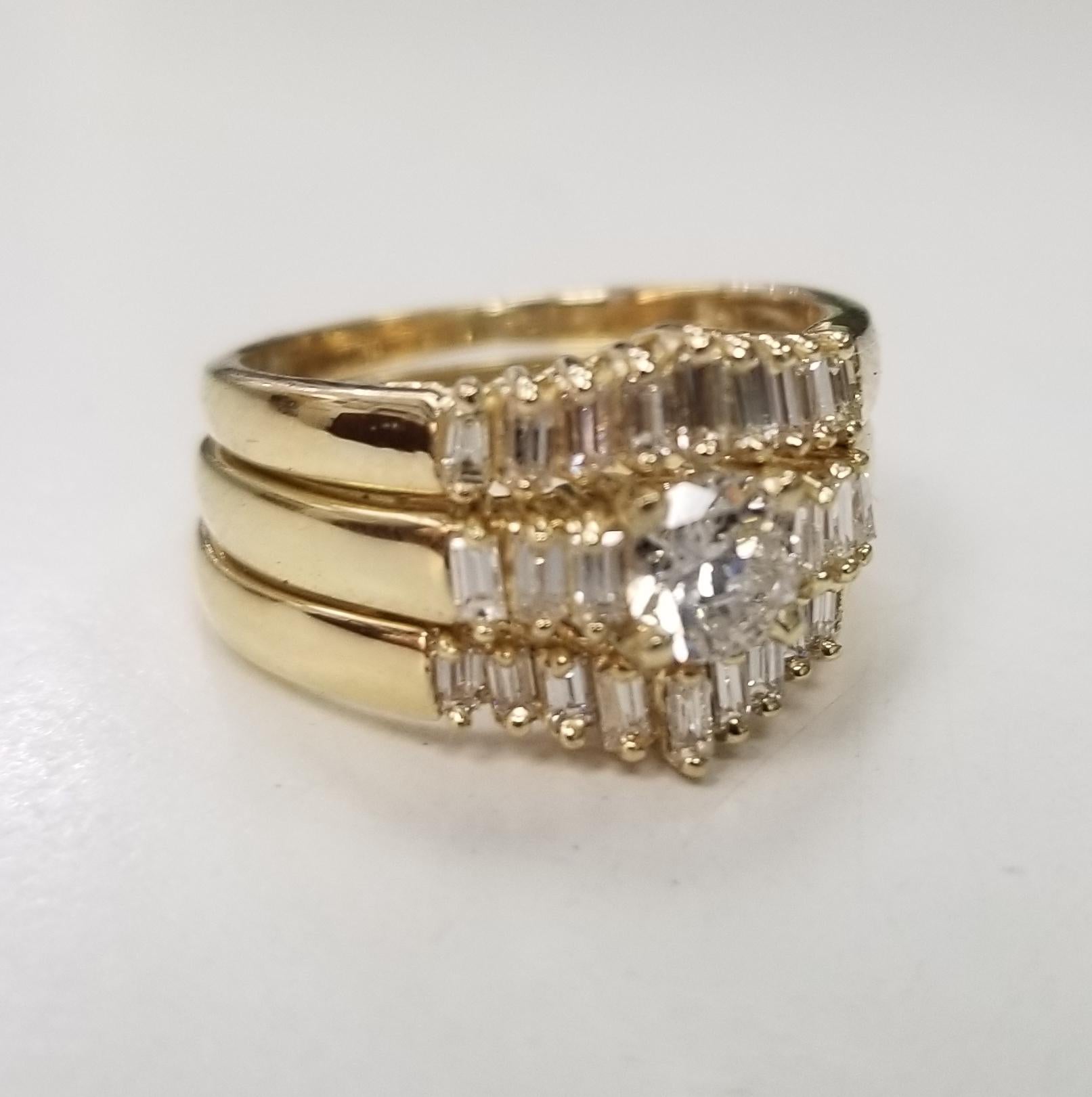 14k yellow gold diamond baguette ring with 2 guard rings, containing 1 brilliant cut diamond; color 