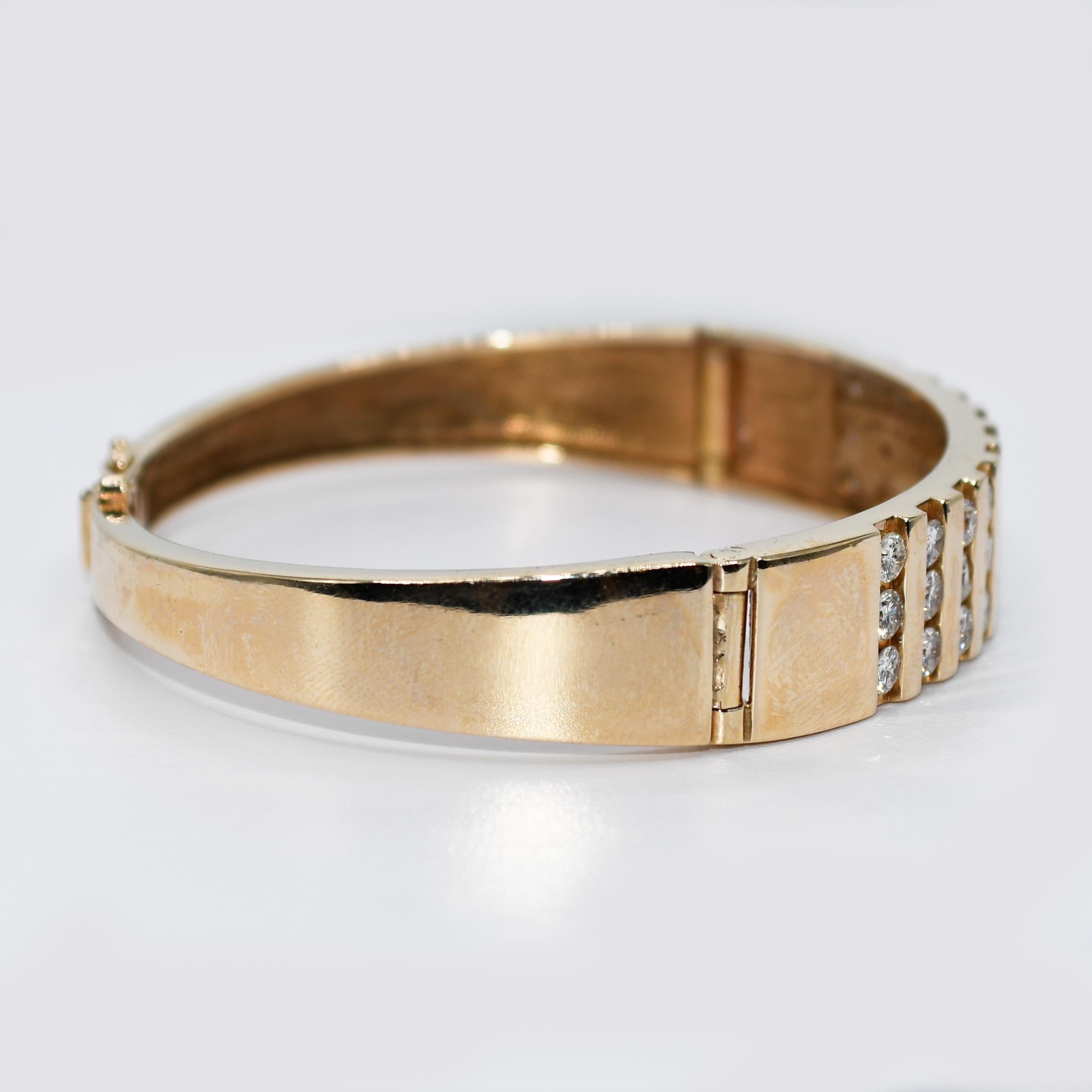 14K Yellow Gold Diamond Bangle Bracelet, 1.75TDW, 23.8g

14k yellow gold and diamond bangle bracelet.
Tests 14k and weighs 23.8 grams.
The diamonds are round brilliant cuts, 1.75 total carats, H to i color, Si clarity.
The bangle measures 10.5mm