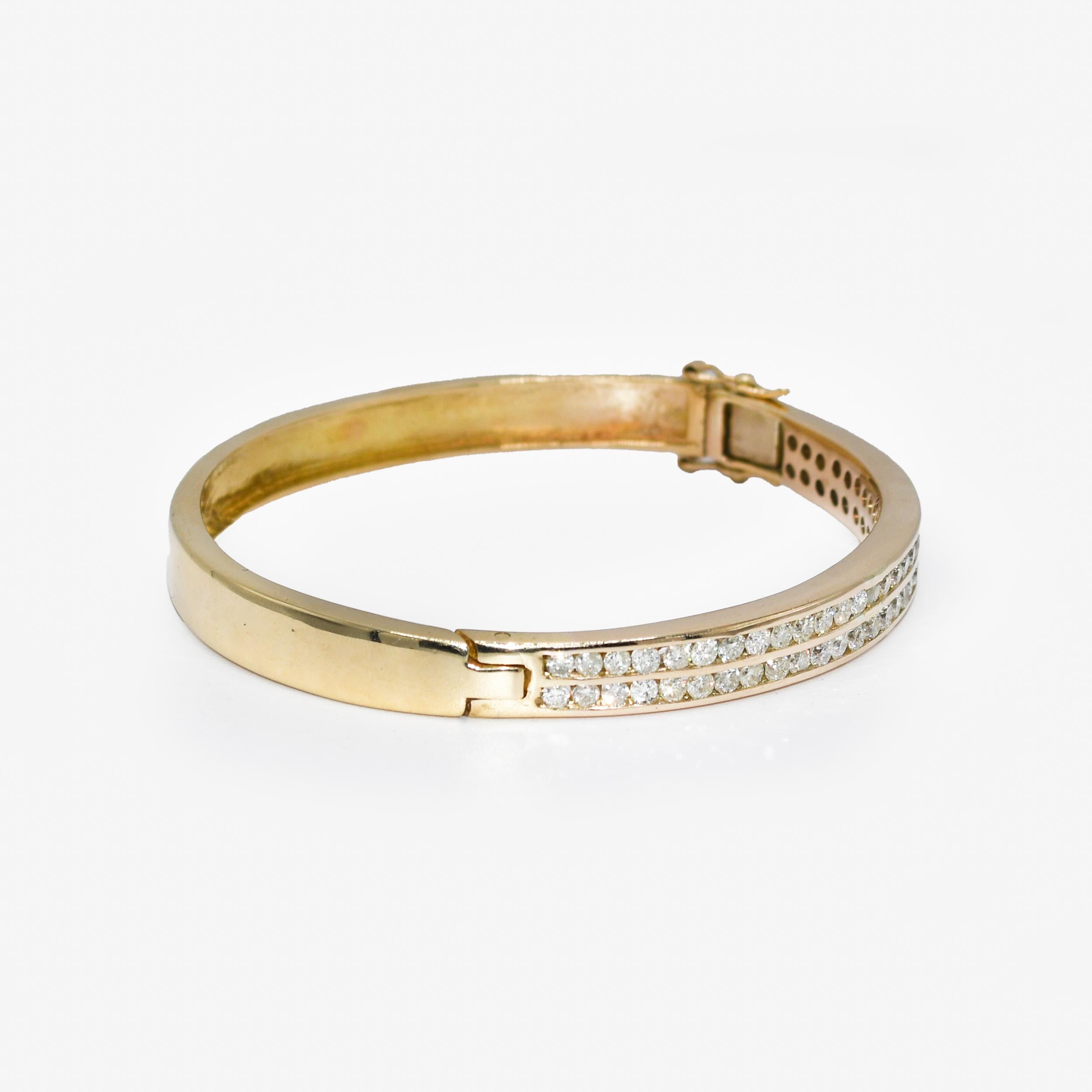 Ladies diamond bangle bracelet with 14k yellow gold setting.
Tests 14k with electronic tester and weighs 34.8 grams.
The diamonds are round brilliant cuts, approximately 2.50 total carats, i, j, k color range, Si to i1 clarity.
The bangle measures