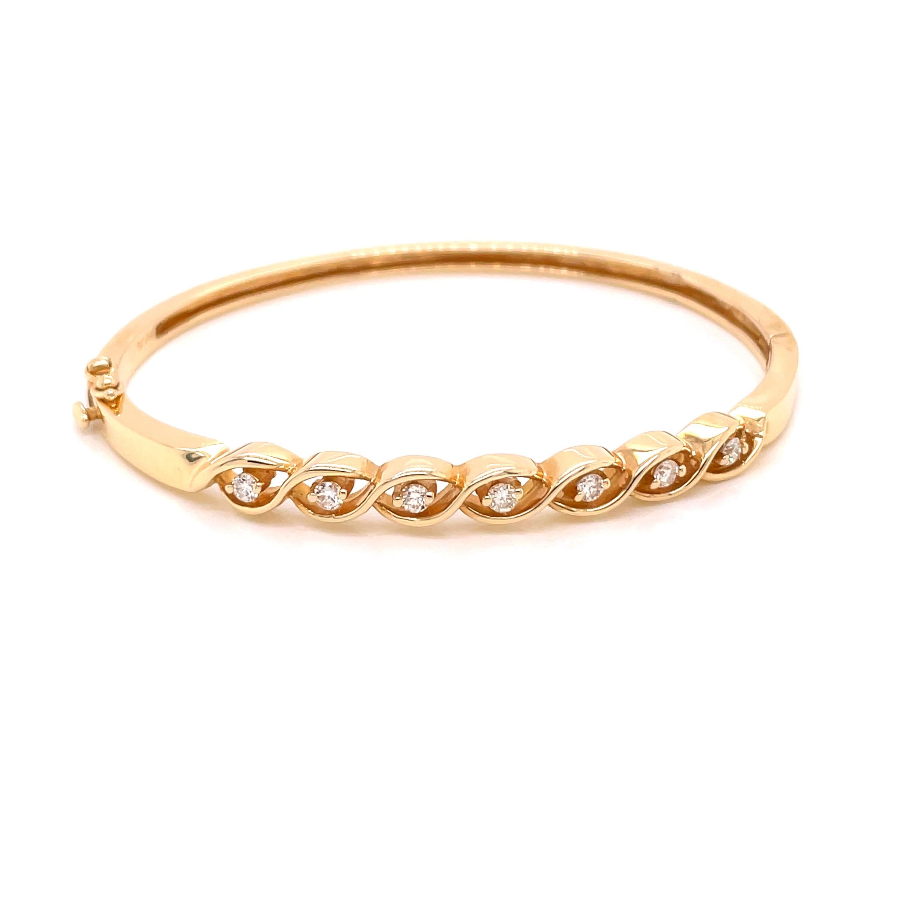14K Yellow Gold Diamond Bangle Bracelet .25ct - The bangle is set with 7 round brilliant diamonds weighing .25ct with G - H color and SI clarity. The width of the bangle on top is 4.9mm and tapers to 2.7mm on the bottom. The inside diameter is 1.9
