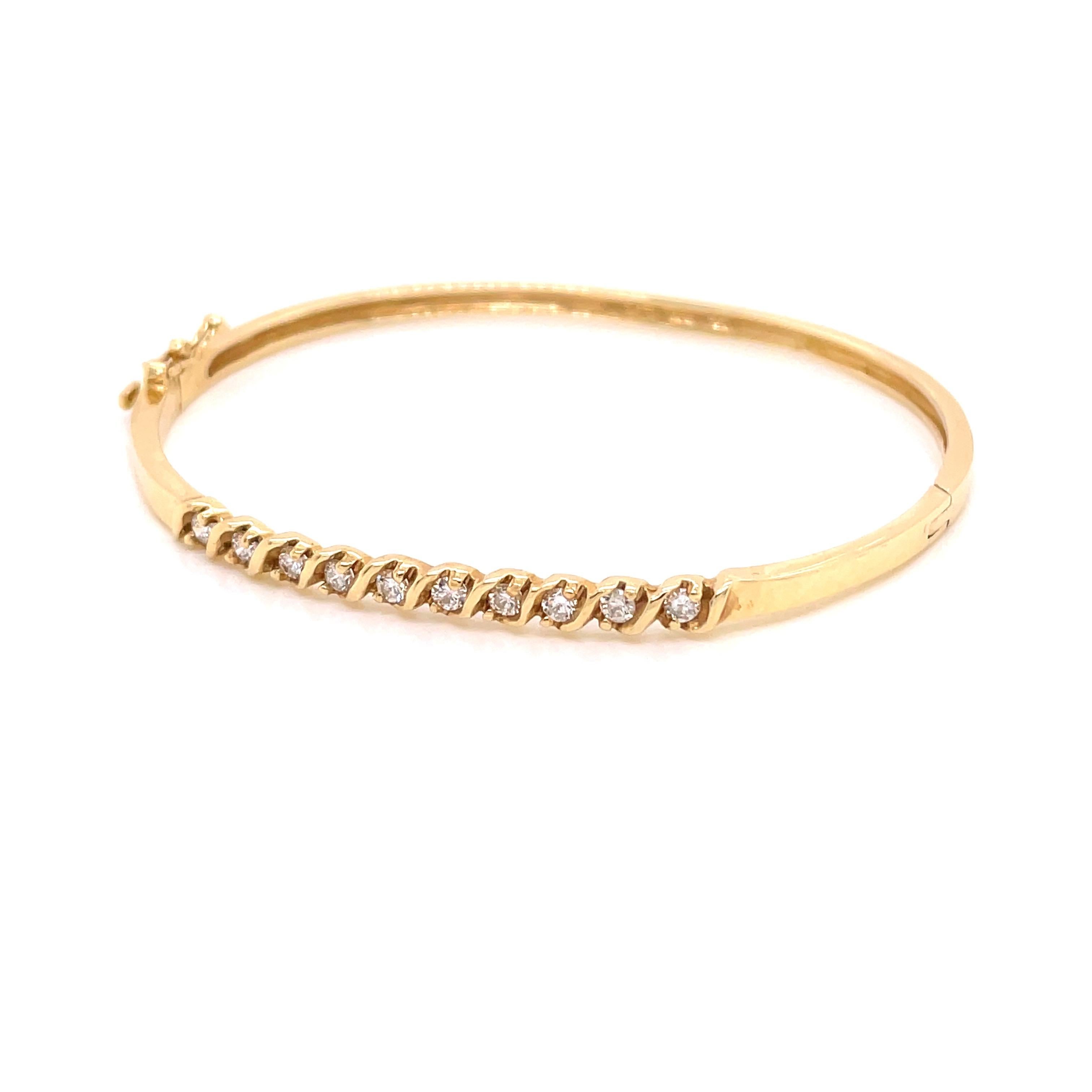 14K Yellow Gold Diamond Bangle Bracelet .47ct - The bangle is set with 10 round brilliant diamonds weighing .47ct with G - H color and VS2 - SI1 clarity with an 'S' bar design. The width of the bangle on top is 3mm and tapers to 2.7mm on the bottom.