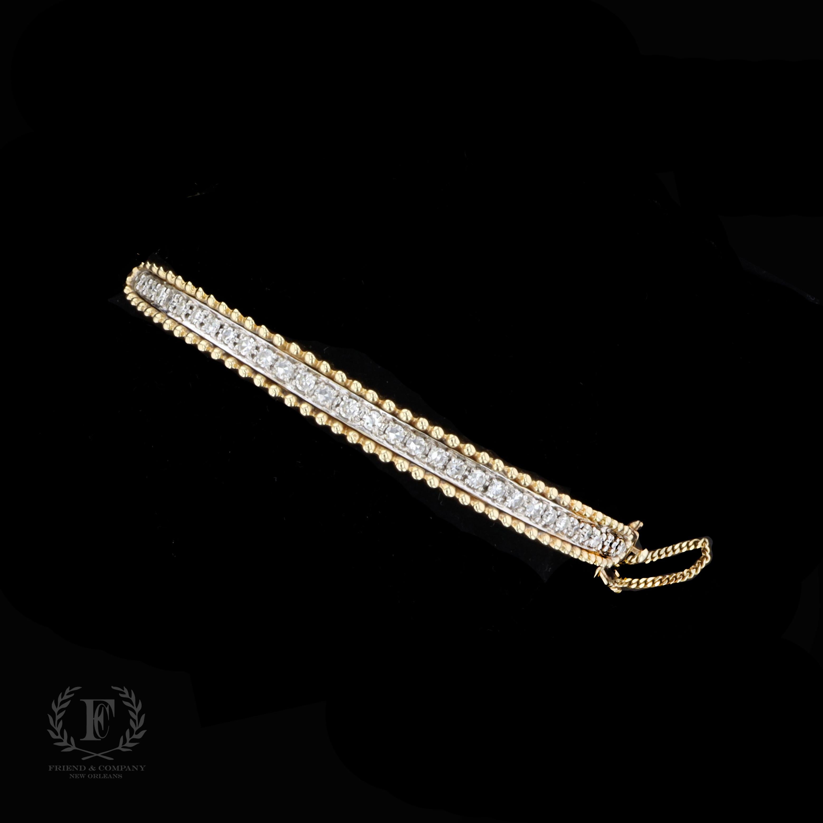 The bangle is set with round cut diamonds that weigh approximately 1.65 carats. The color of the diamonds is G with VS clarity. The bangle measures 6 millimeters in width at the widest base and will fit a standard wrist size. The bangle is stamped