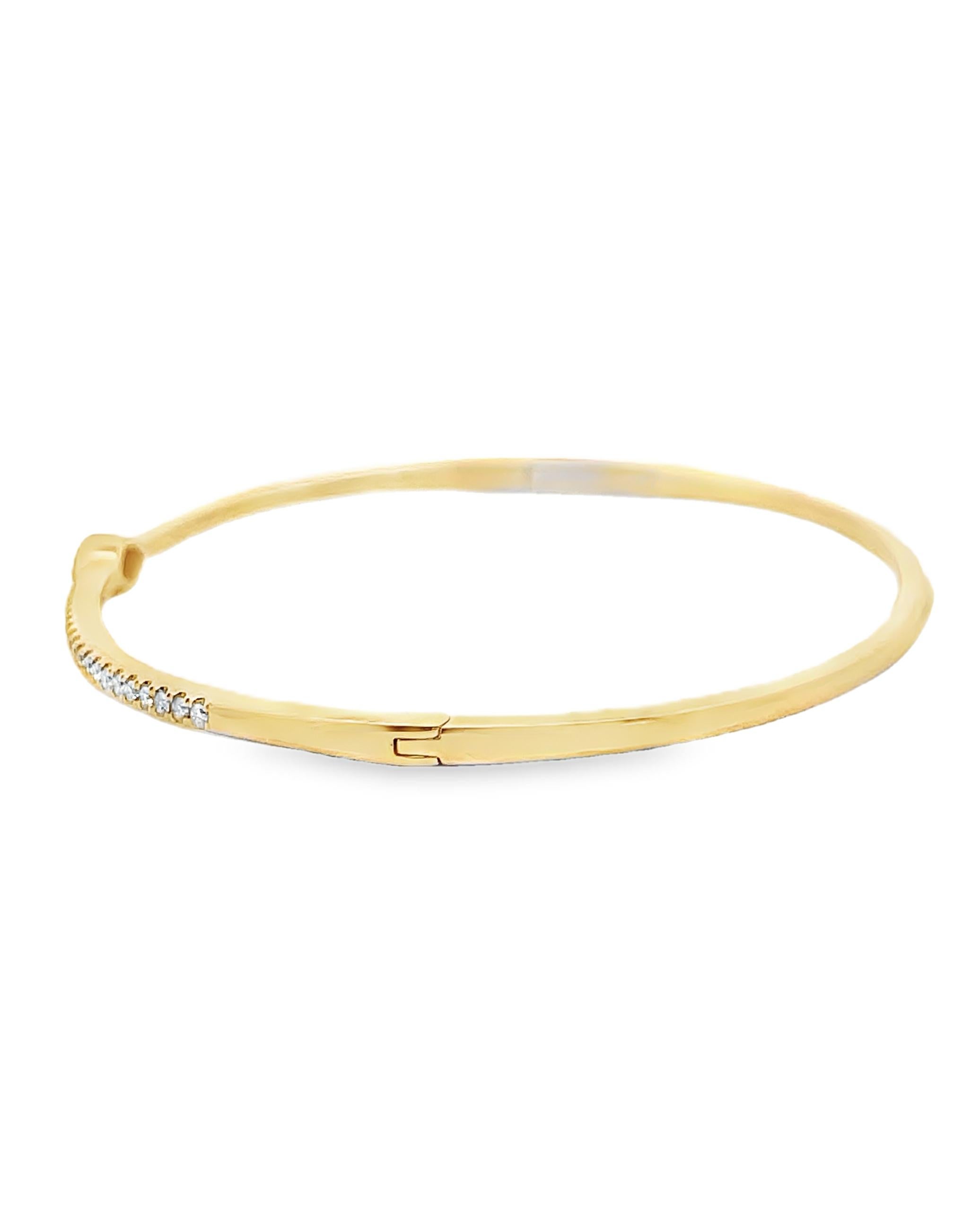 14K yellow gold bangle bracelet with round faceted diamonds weighing 0.36 carat total and one center marquise shape diamond weighing 0.20 carat.

- Diamonds are G/H color, SI clarity.