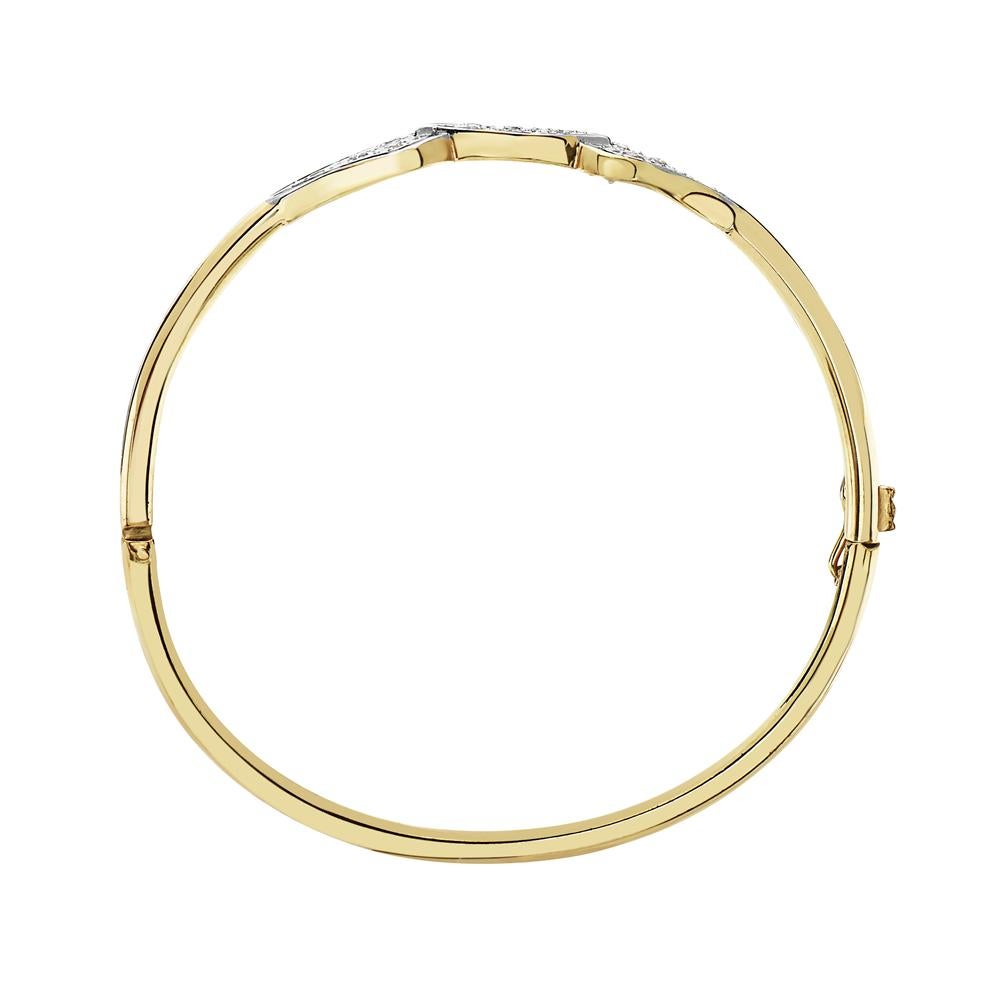 This bangle features 0.35 carats of round brilliant diamonds set in 14K yellow gold with a hidden side clamp closure. 2.25 inches inches in diameter. 8.9 grams. Made in USA. 

Viewings available in our NYC showroom by appointment.