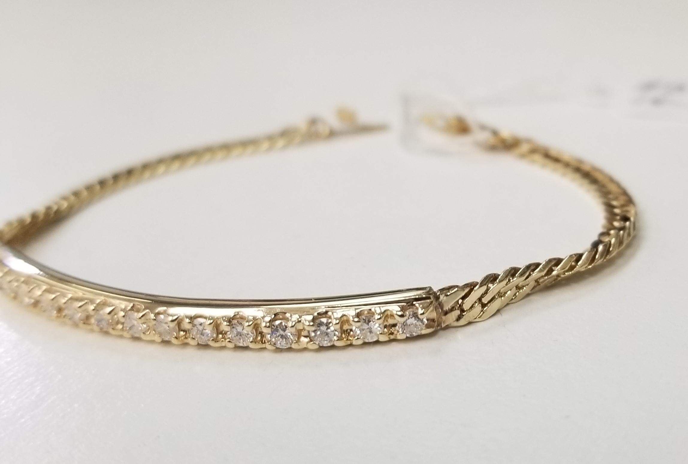 14k yellow gold diamond bar and chain bracelet containing 14 round full cut diamonds; color G, clarity VS and weight .70pts. the bracelet will fit a 7 inch wrist.