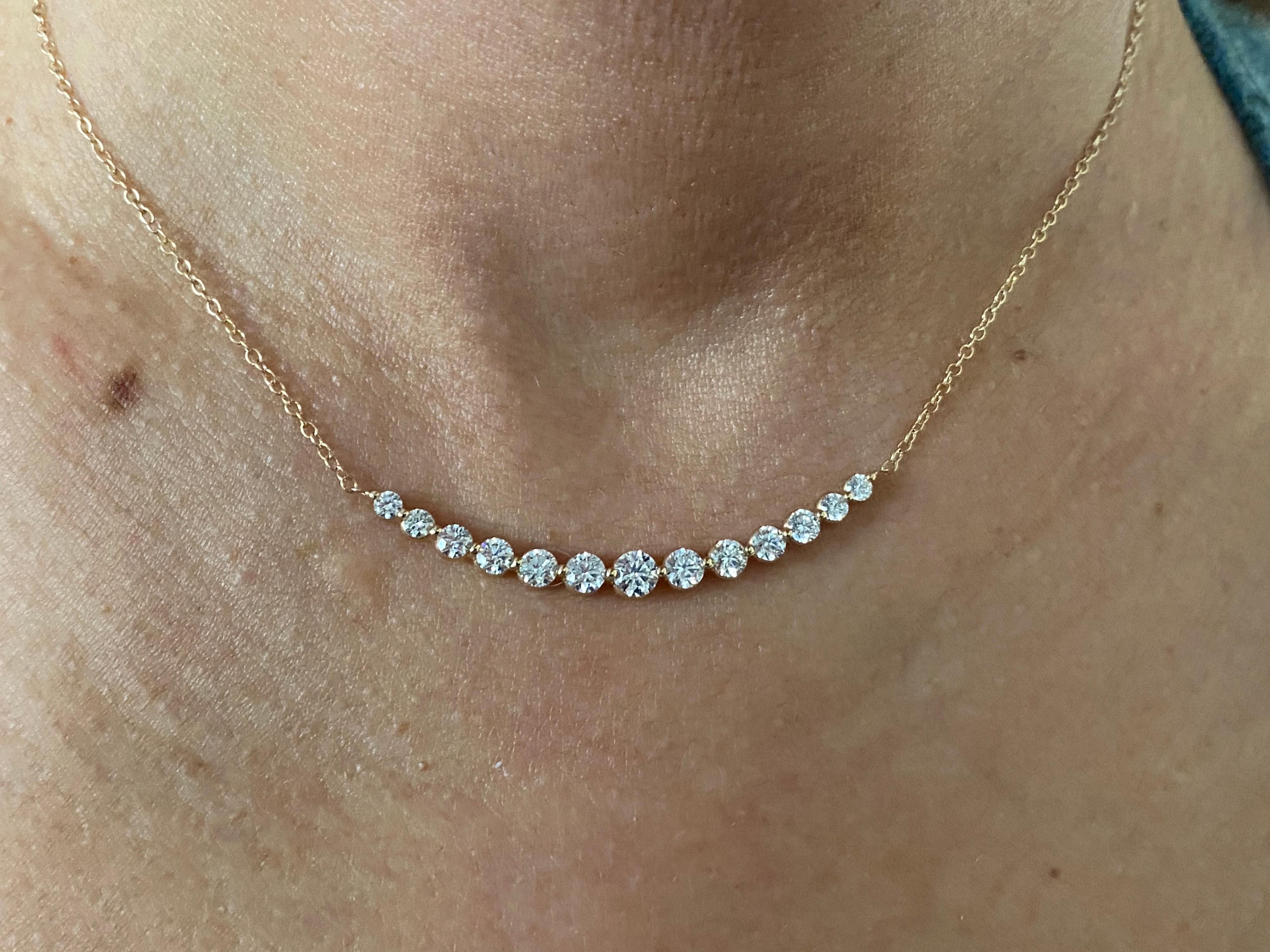 Diamond bar pendant set in 14K yellow gold. The center stone weighs 0.30 carats. The total carat weight of the pendant is 1.70 carats. The stones are graduated in size. The color of the diamonds are G, the clarity is SI. The total length of the