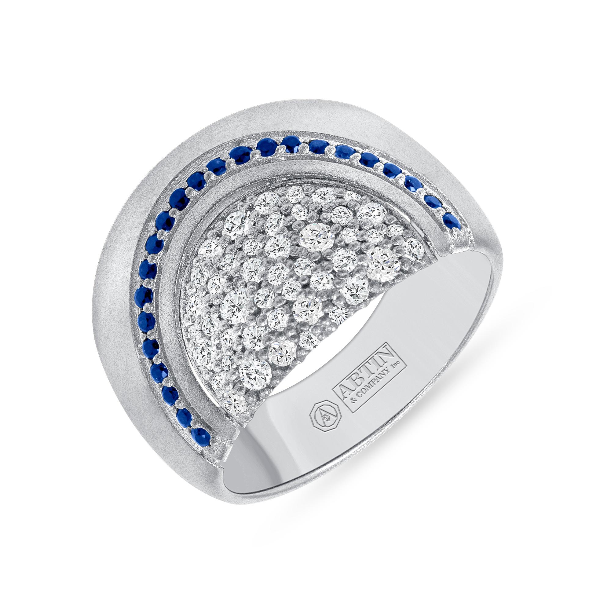Crafted in 14K gold, this exquisite ring features a dazzling arrangement of 0.68 carats of diamonds and blue sapphire. Its high-domed design sparkles with round brilliant-cut diamonds and round-cut blue sapphire. The rich, satin blue of the blue