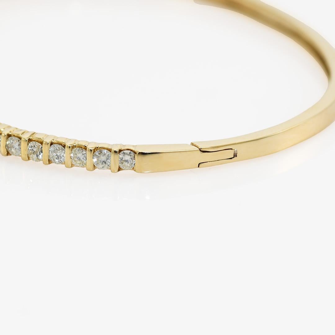 Ladies 14k yellow gold and diamond bangle.

Stamped 14k and weighs 9 grams gross weight.

The diamonds are round brilliant cuts, .75 total carats, J-K color, i1 clairity.

The bracelet measures 6 3/8 inches on the inside and 3mm wide at the