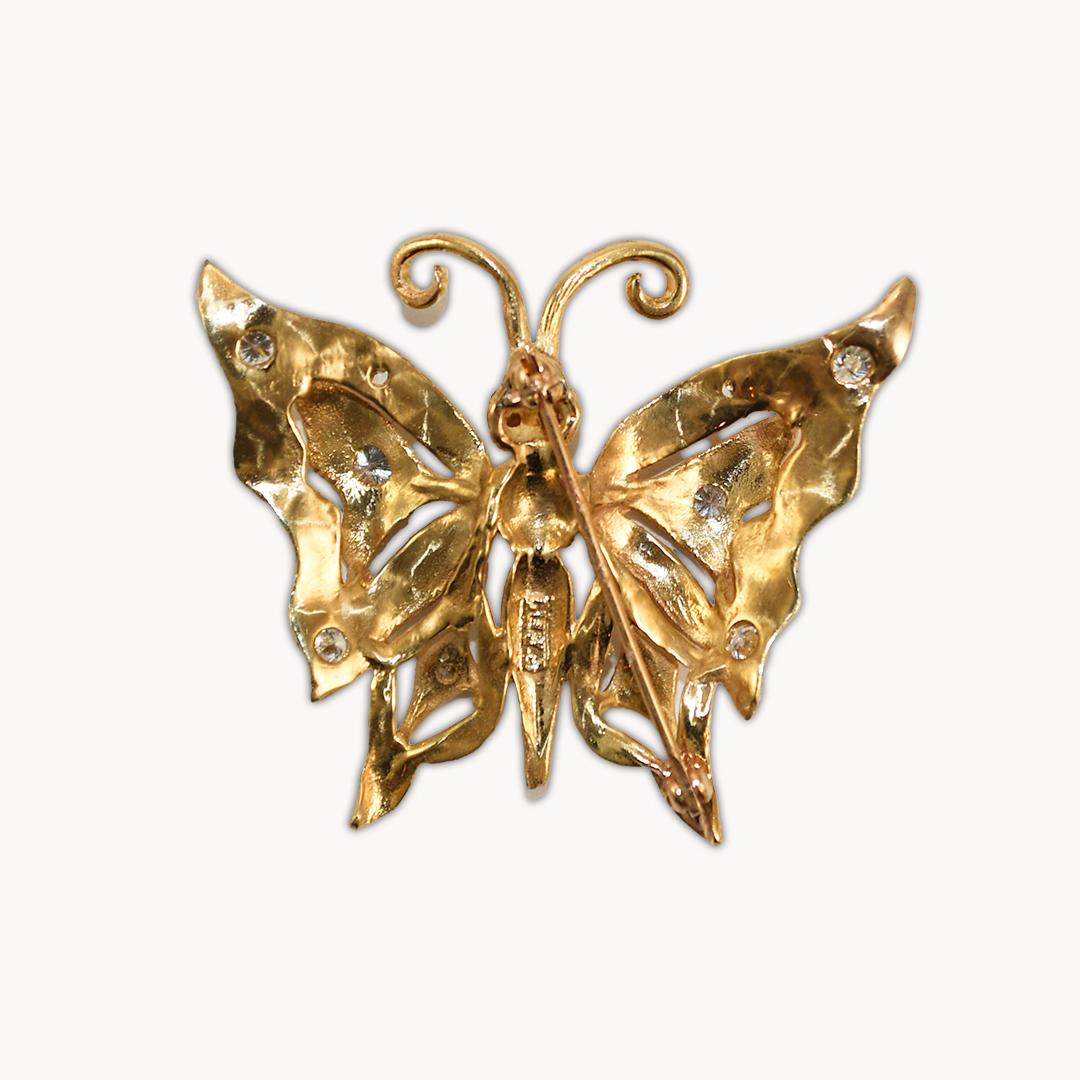 14k yellow gold brooch with diamonds. 
Tests 14k and weighs 8.4 grams.
There are 12 round brilliant cut diamonds, .75 total carats, G to H color, VS clarity.
The top surfaces of the brooch have a florentine finish.
The brooch measures 1 1/2 by 1 1/2