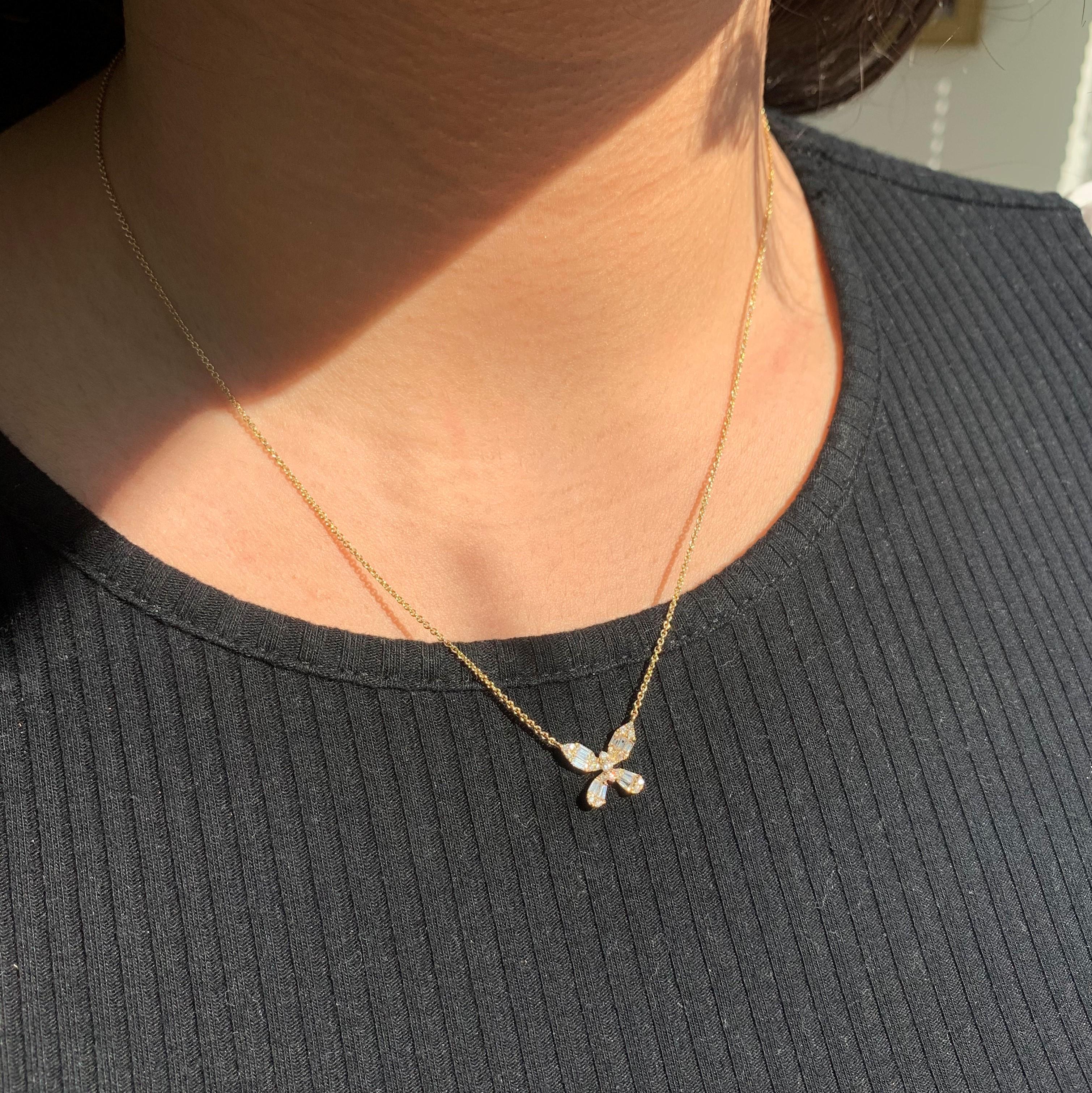 This is a Beautiful Baguette Butterfly Necklace! Crafted of 14K Gold featuring stunning baguette diamonds surrounded with sparkling round Diamonds! Chain is Adjustable 16-18