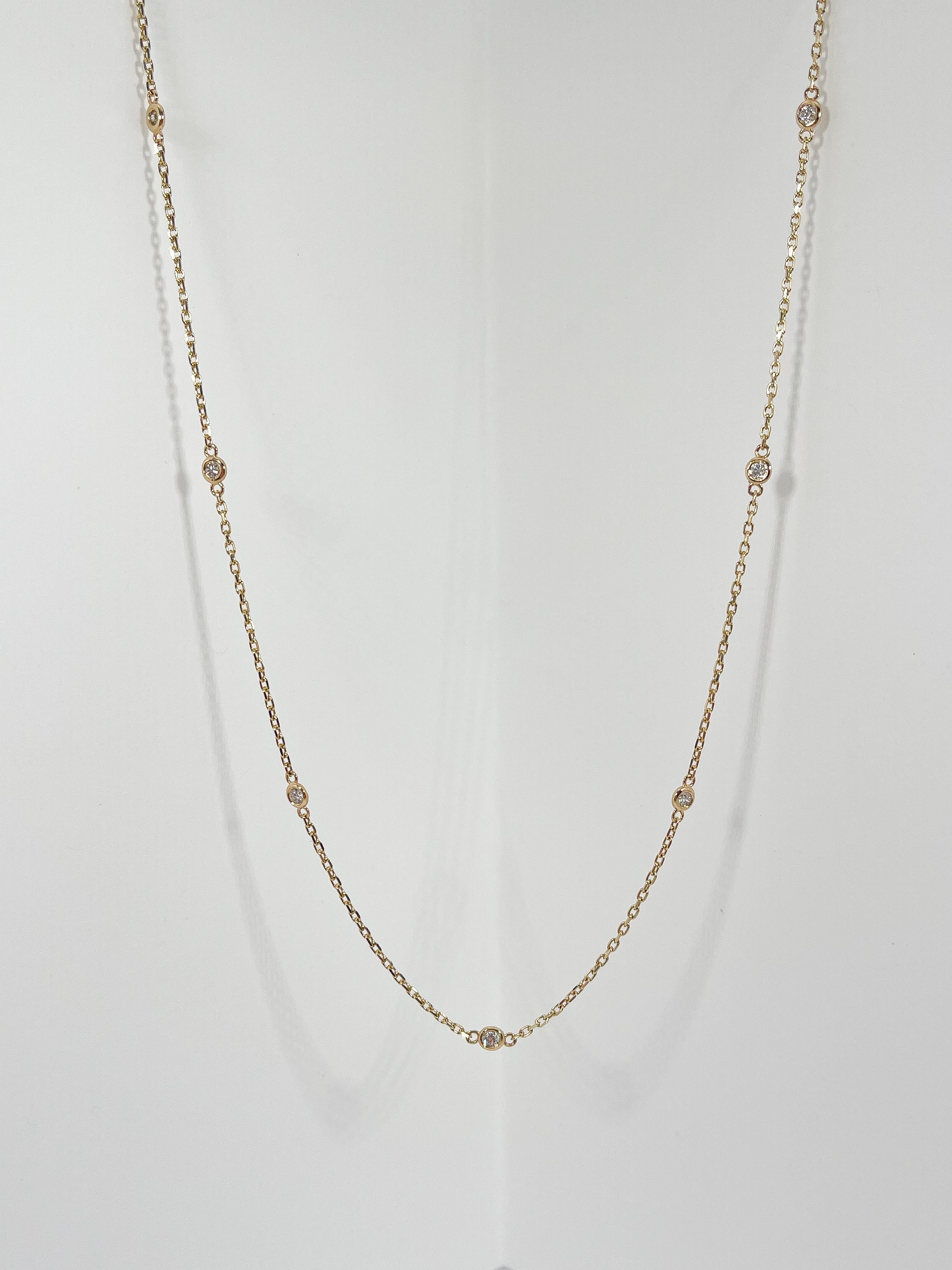 14k yellow gold diamond by the yard .30 CTW necklace. This necklace has 10 round diamond stations that have a diameter of 2.8 mm, the length is 18 inches, and it has a total weight of 3 grams.