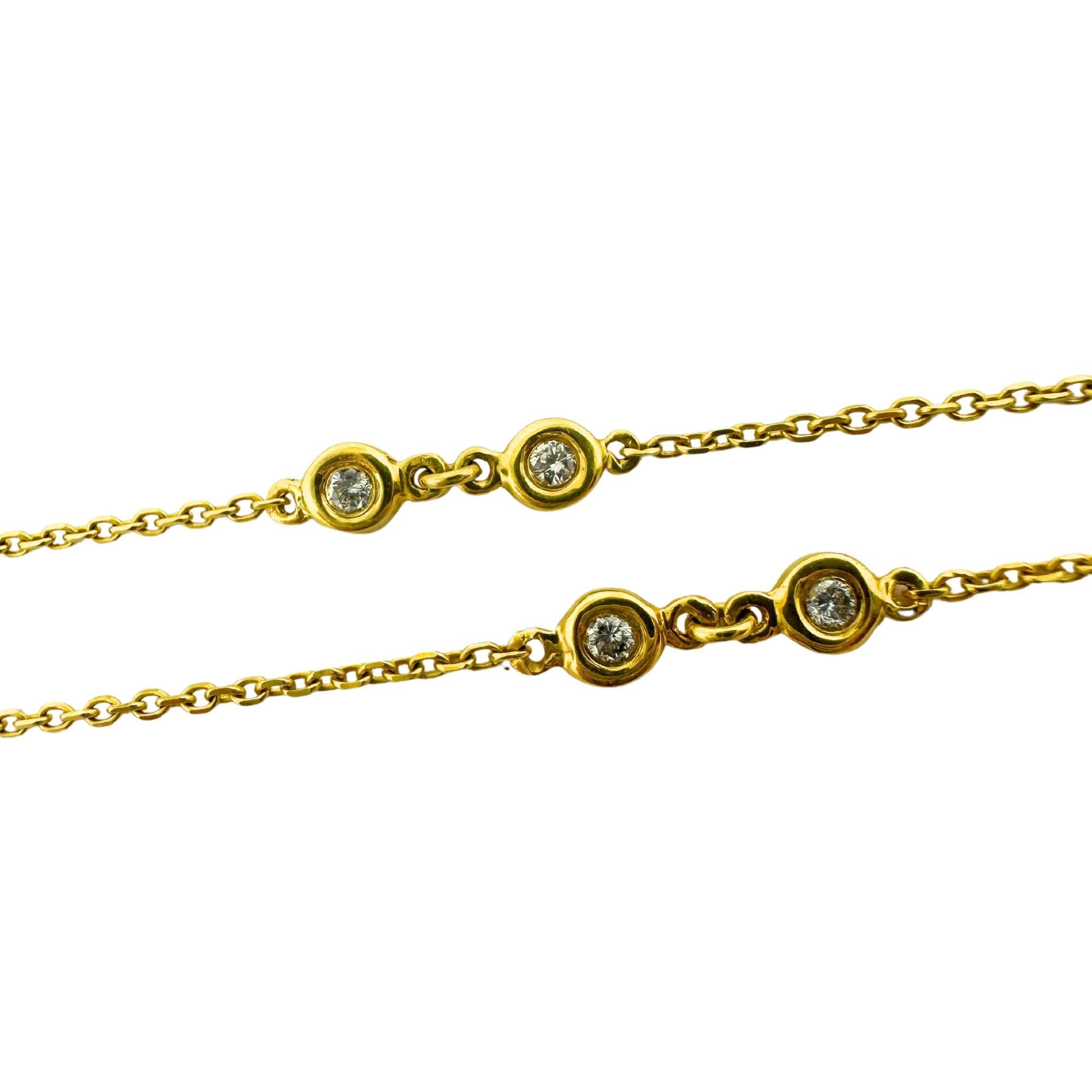 This elegant 14K Yellow Gold Diamond By the Yard Chain Necklace features delicate diamonds totaling 0.22 carats, set in a timeless 19-inch chain. In good condition with some minor surface wear, it showcases the quality craftsmanship marked “14K” and