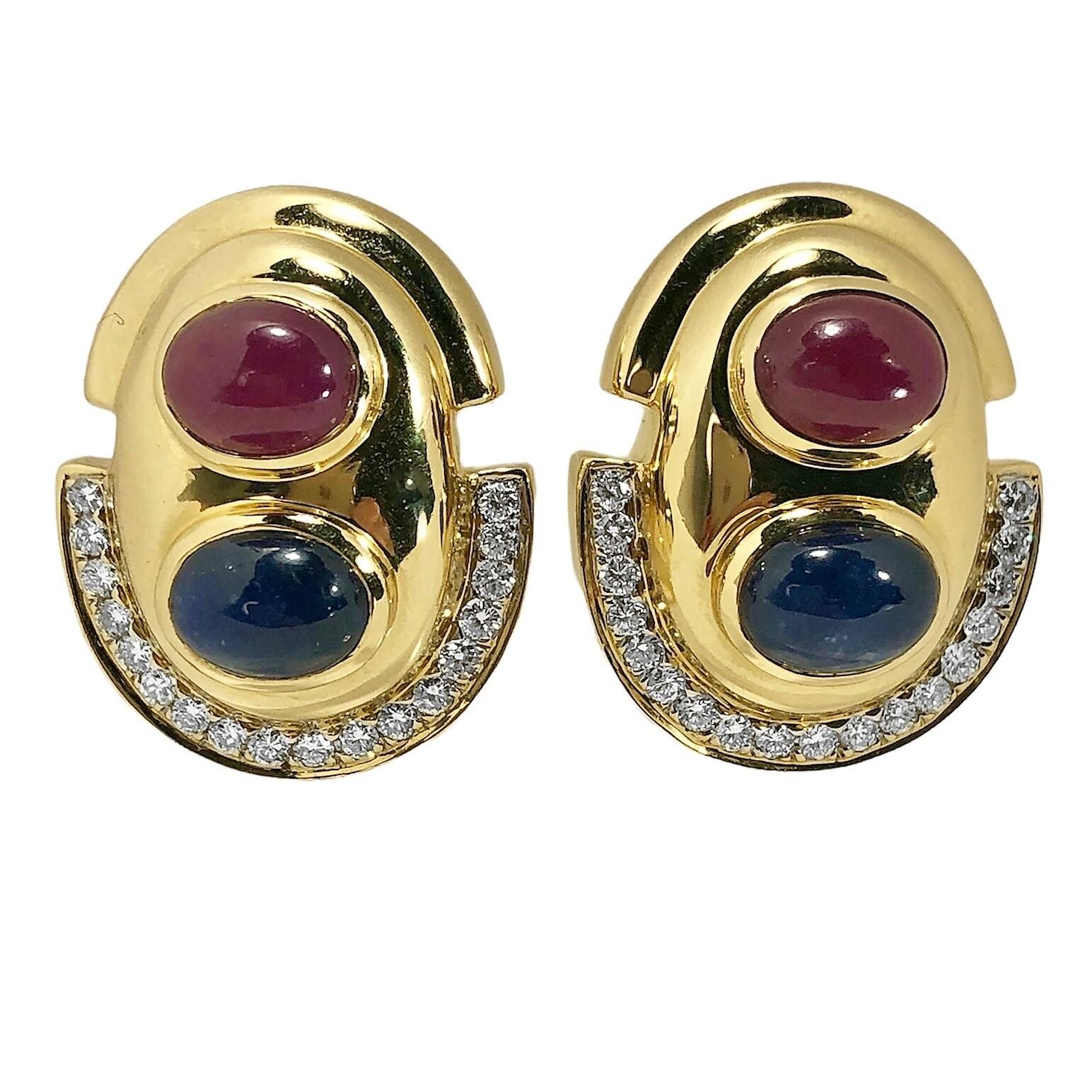 This very stylish pair of 14K yellow gold contemporary earnings is set with two ruby cabochons, two sapphire cabochons, and thirty six brilliant cut diamonds. Total approximate colored stone weight is 14.00ct. The rubies and sapphires are uniform in