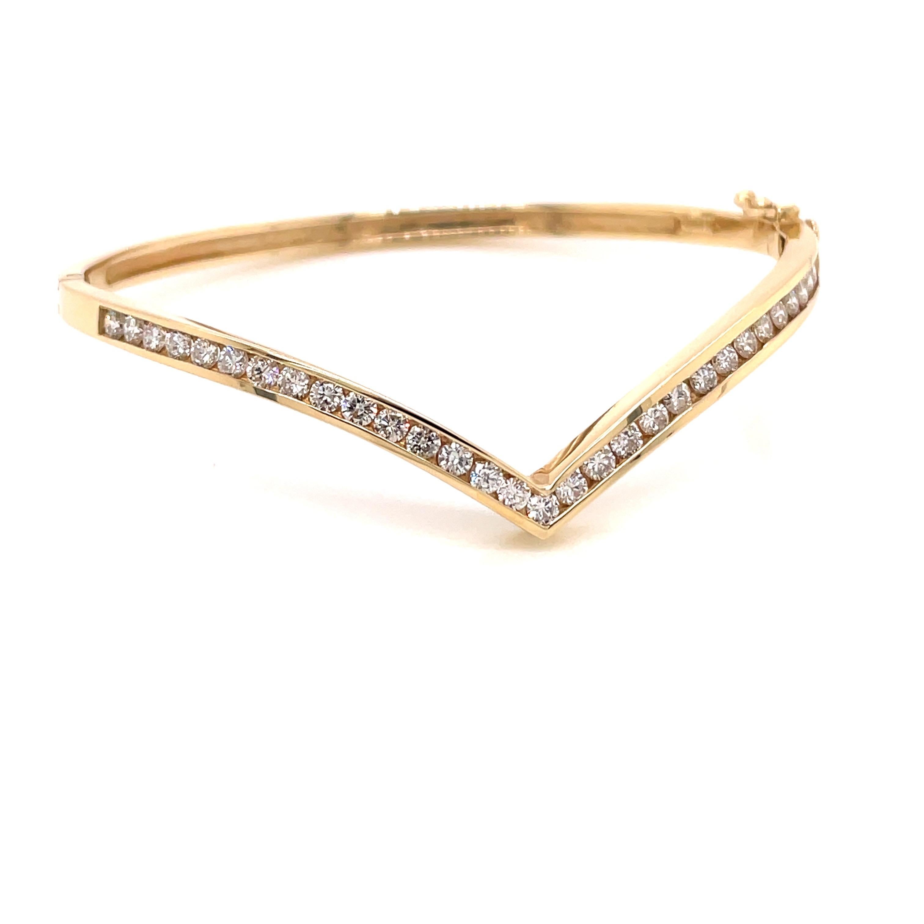 14K Yellow Gold Diamond Chevron Bangle Bracelet 1.39ct - The bangle is channel set with 31 round brilliant diamonds weighing 1.39ct with G - H color and VS2 - SI1 clarity. The width of the bangle is 3.2mm and the point of the chevron extends 1/2