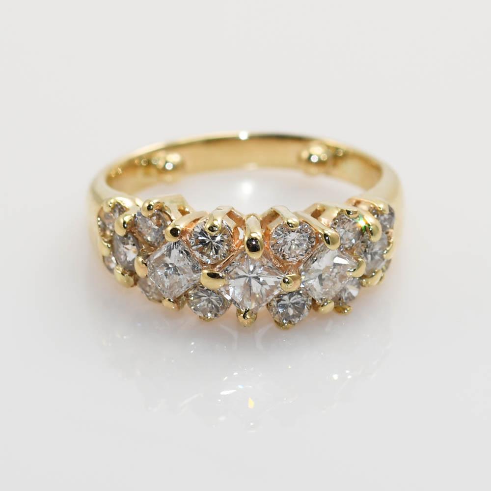Ladies diamond cocktail ring in 14k yellow gold setting.
Tests 14k and weighs 4.8 grams.
There are three .25 carat princess cut diamonds.
One has a chip on the surface.
The other diamonds are round brilliant cuts, .75 total carats.
Most of the