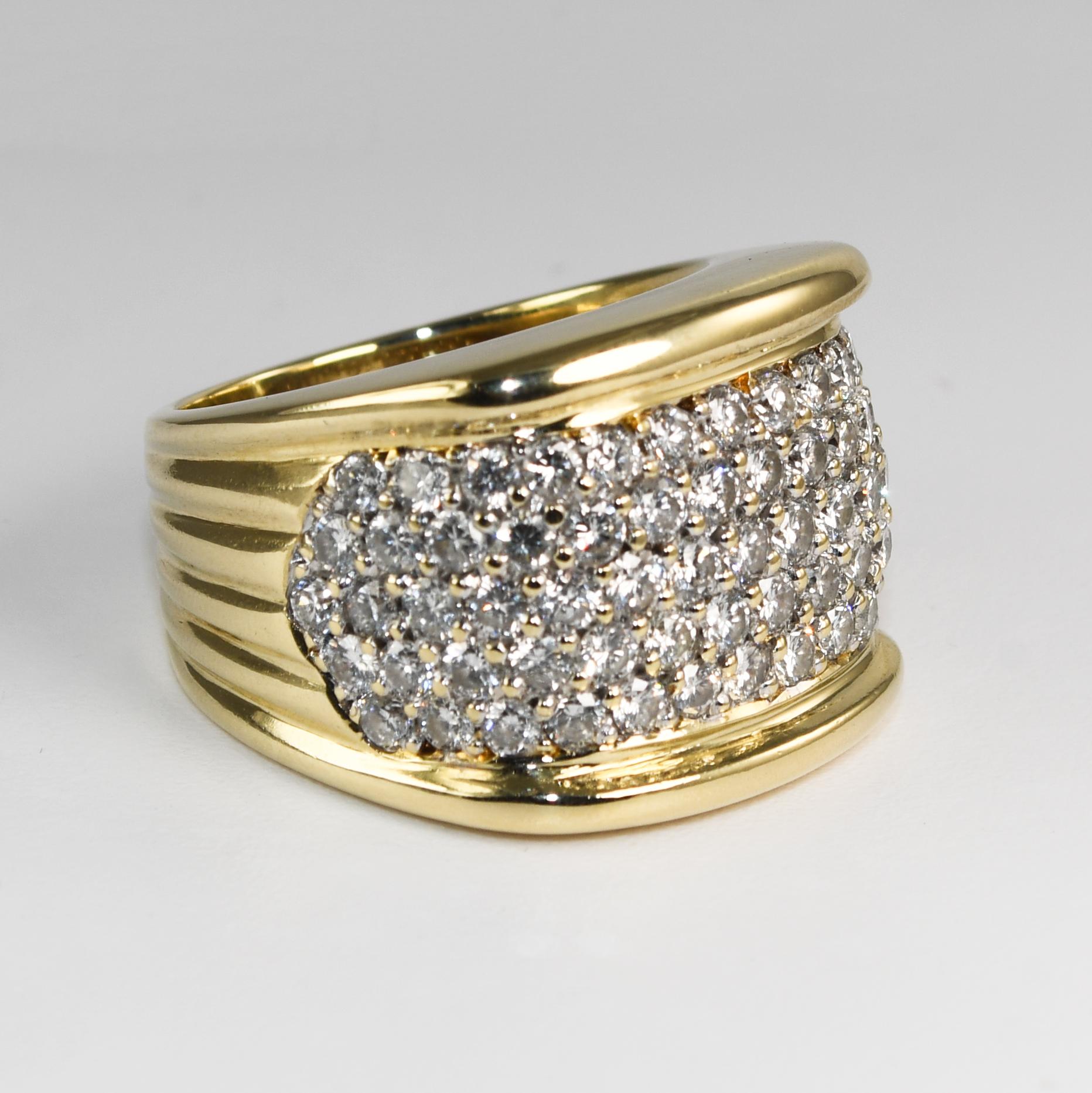 Ladies 14k yellow gold and diamond cocktail ring.
Stamped 14k and weighs 20.9 grams.
The diamonds are pave set, round brilliants, 2.25 total carats, H, i, j color range, Si clarity.
The top of the ring measures 17mm wide.
Ring size is 8 and can be