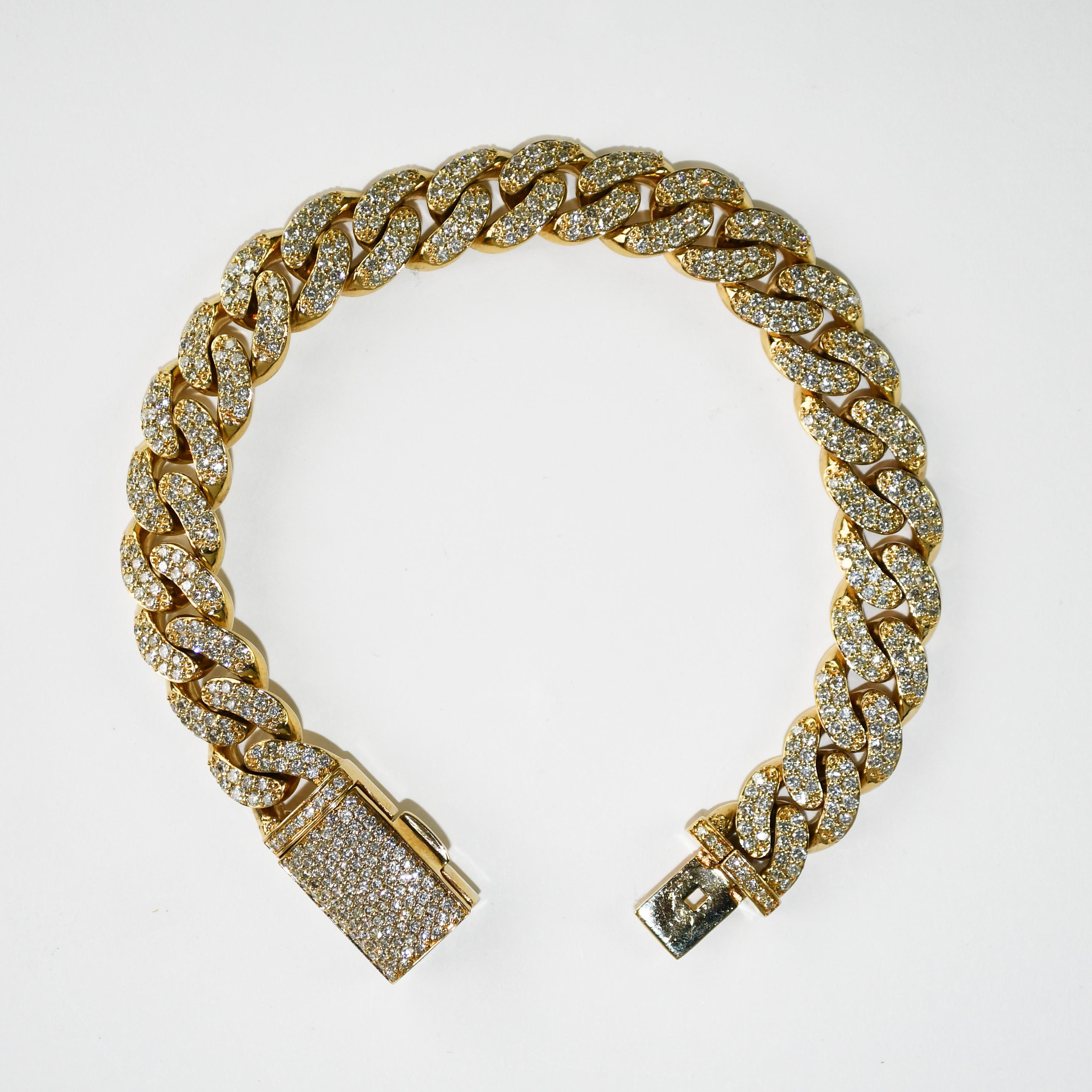 Custom made, 14k yellow gold and diamond bracelet.
Stamped 14k and weighs 68.4 grams gross weight.
Curb link style.
The diamonds are round brilliant cuts, 5.30 total carats, h, i, j color range, Si clarity.
The bracelet measures 8 3/4 inches long