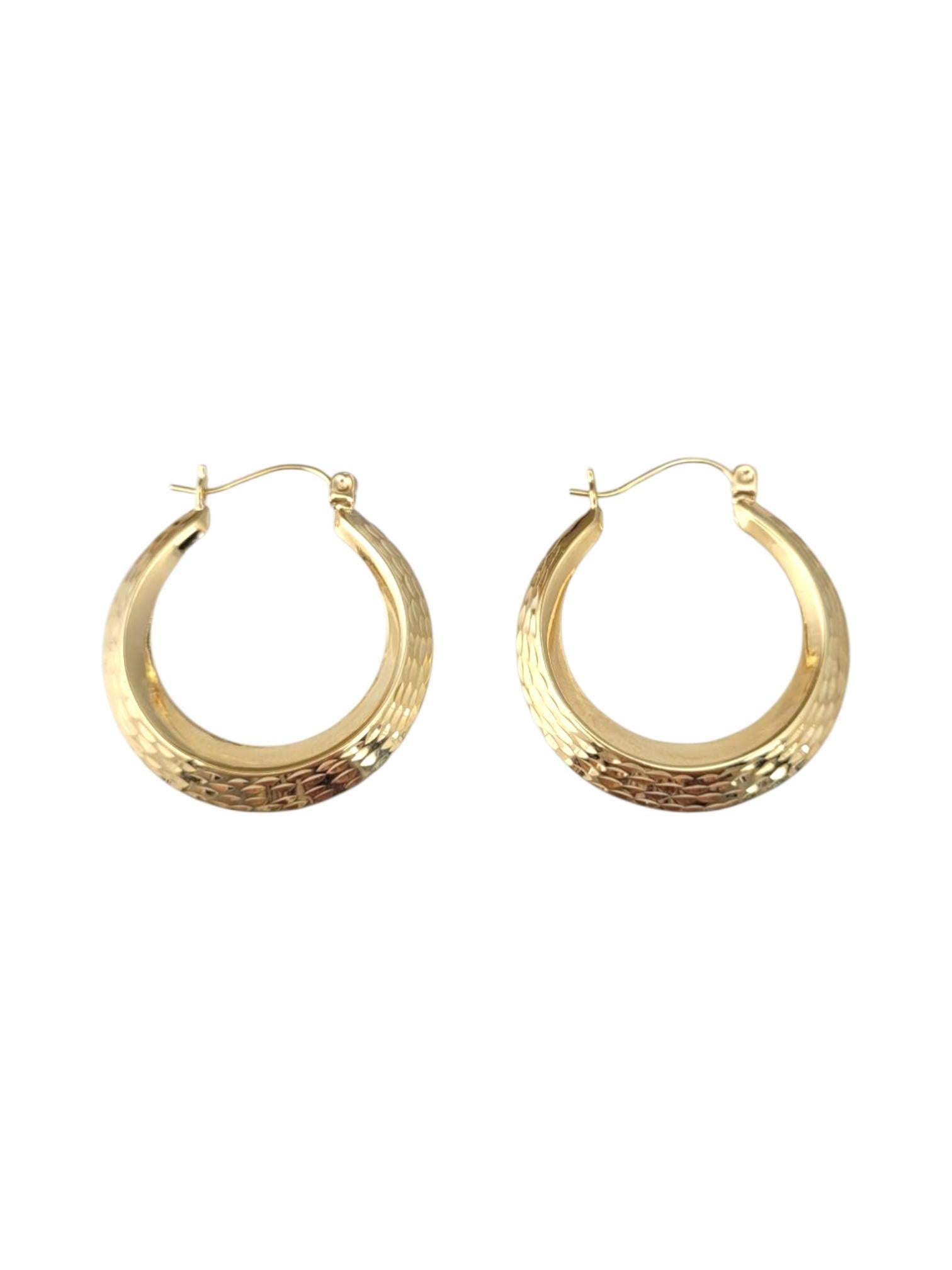 14K Yellow Gold Diamond Cut Hoop Earrings -

These hammered hoop earrings feature a textured finish that catches the light beautifully, adding depth and dimension to a classic silhouette. Their artisanal look offers a modern twist on timeless