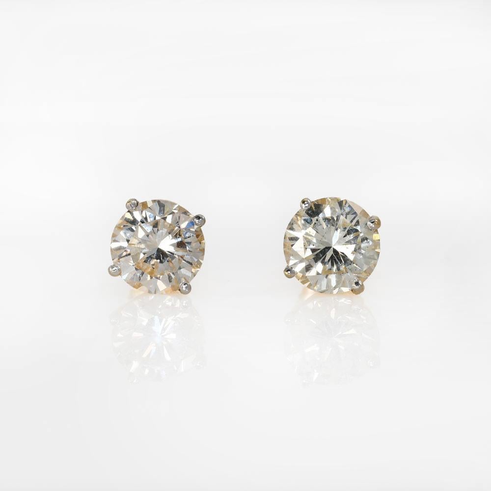 14K Yellow Gold Diamond Earrings 4.19TDW, 2.7gr
Diamond stud earrings with 14k yellow gold settings.
The setting are screw backs for pierced ears, stamped 585.
The diamonds are round brilliant cuts, total diamond weight is 4.19 carats.
One diamond