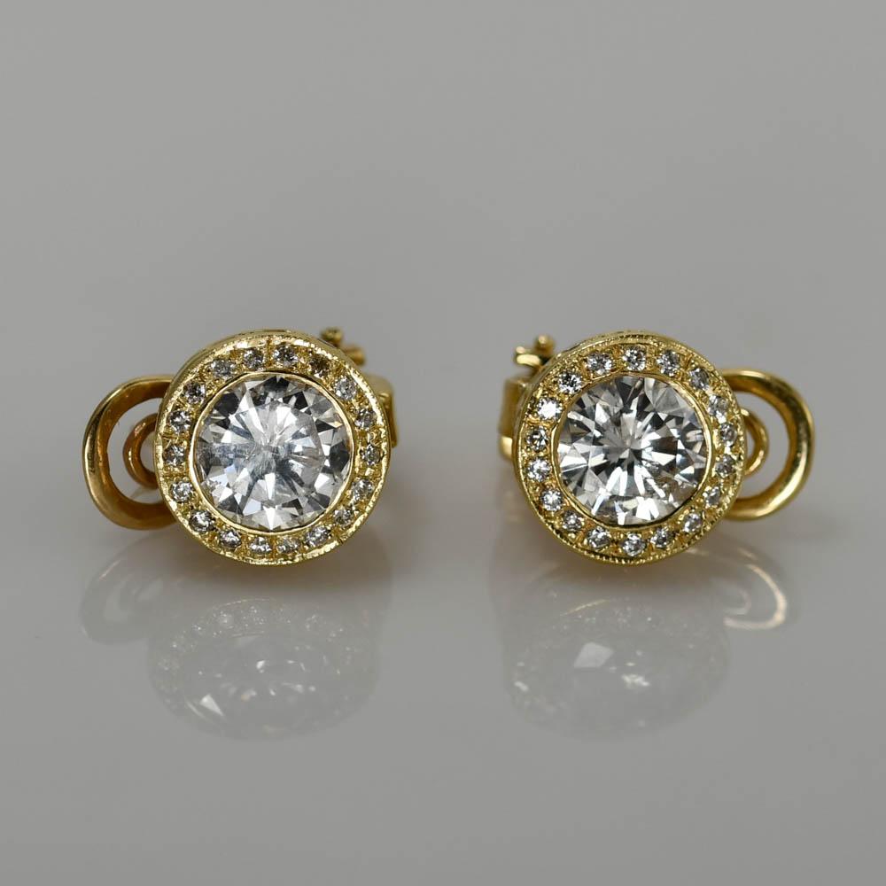 Ladies diamond earrings in 14k yellow gold settings.
Stamped 14k and weighs 6.9 grams.
The center diamonds are round brilliant cuts, H color, i1 clarity, 2.60 total carats.
On the sides are small round brilliant cuts, .75 total carats, G to H color,