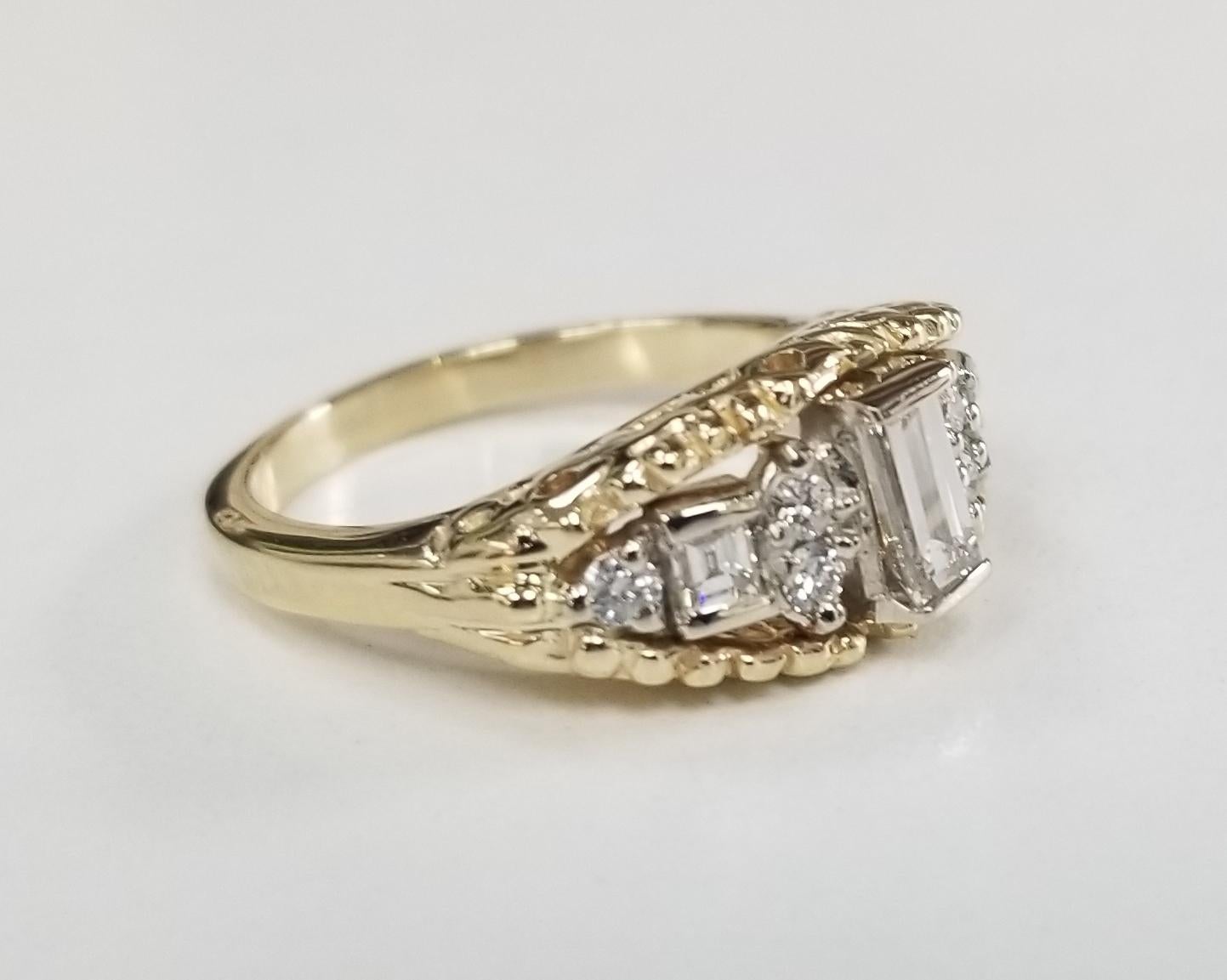 14k yellow gold diamond emerald cut diamond ring with white gold insert
 Specifications:
    MAIN stone: Diamond Emerald cut .35pts.
    SIDE STONE: 8 PCS Diamonds 0.31CTW    
    COLOR/clarity: G/VS2  
    metal: 14K YELLOW GOLD
    type: RING
   