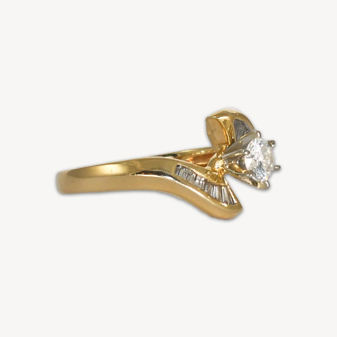 Engagement diamond ring in 14k yellow gold.
Stamped 14k and weighs 3.4 grams.
The center diamond is .30 carats, H to I color, Si1 clarity, and very good cut.
The baguette diamonds on the side are H to I color, VS clarity, .15 total carats.
The ring