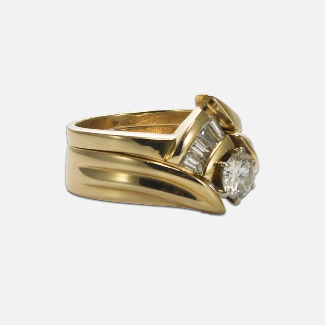 Diamond ring set in 14k yellow gold.
Stamped 14k and weighs 8.2 grams.
The center diamond is a round brilliant cut, G color, SI2 clarity, and .45 carats. 
On the wedding band are four baguette diamonds, G color, VS clarity, and .45 total carats.
The