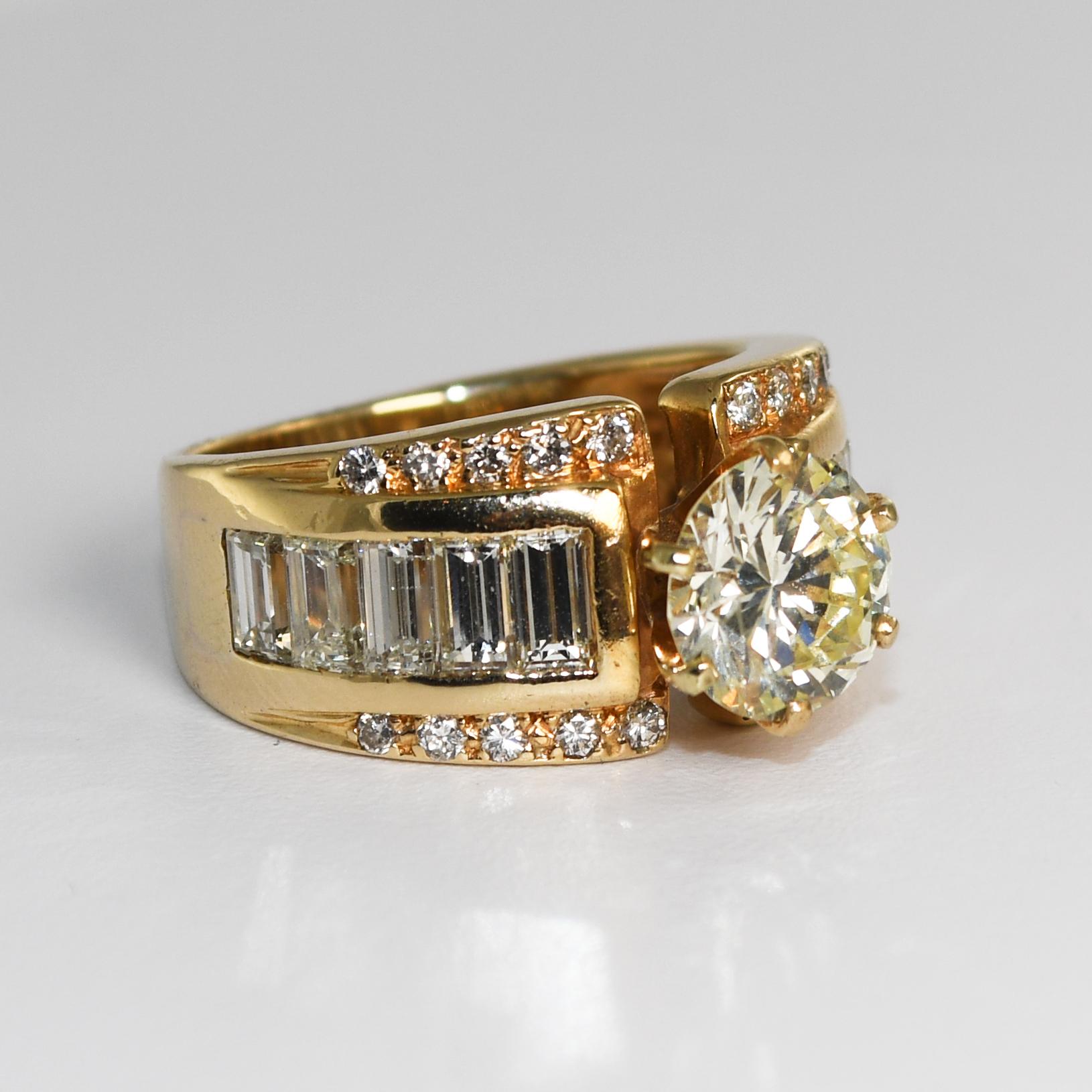 Diamond Ring in 14k yellow gold.
Stamped 14k and weighs 8.2 grams.
The center diamond is a round brilliant cut, 1.71 carats, slightly yellow, VS clarity, very good cut.
The side diamonds are rectangle, step cuts, and round brilliant cuts, 1.50 total