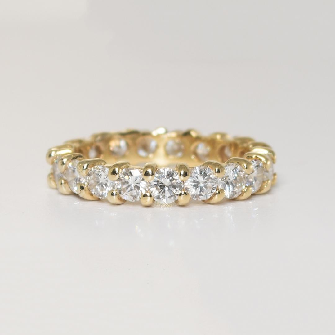 14k yellow gold and diamond eternity ring.
Tests 14k and weighs 2.9 grams gross weight.
The diamonds are round brilliant cuts, 2.00 total carats, G to H color, Vs to Si clarity, and good cuts.
The ring measures 3.8mm wide.
The ring size is
