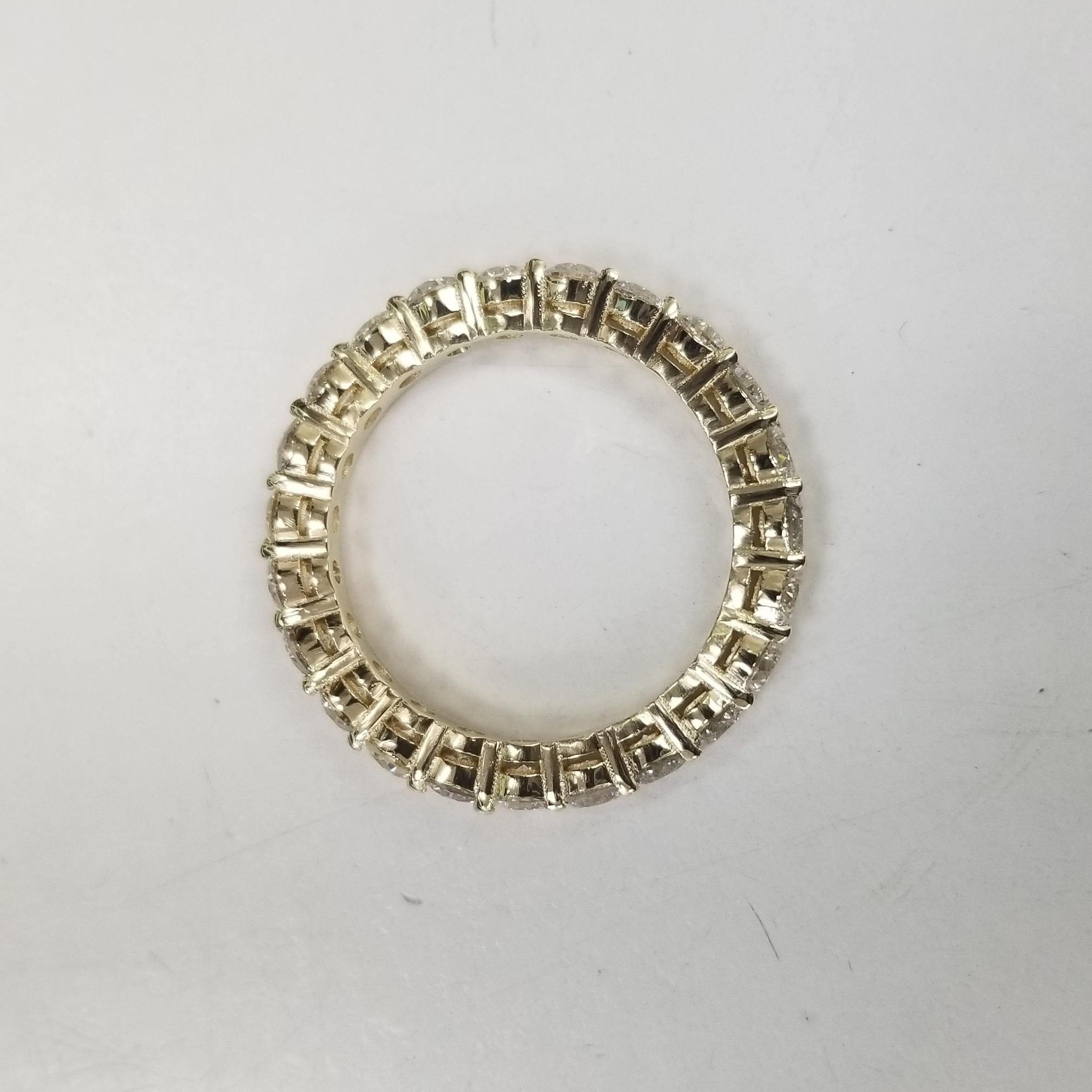 Contemporary 14K Yellow Gold Diamond Eternity Ring with 2.58cts. Set with Shared Prong For Sale