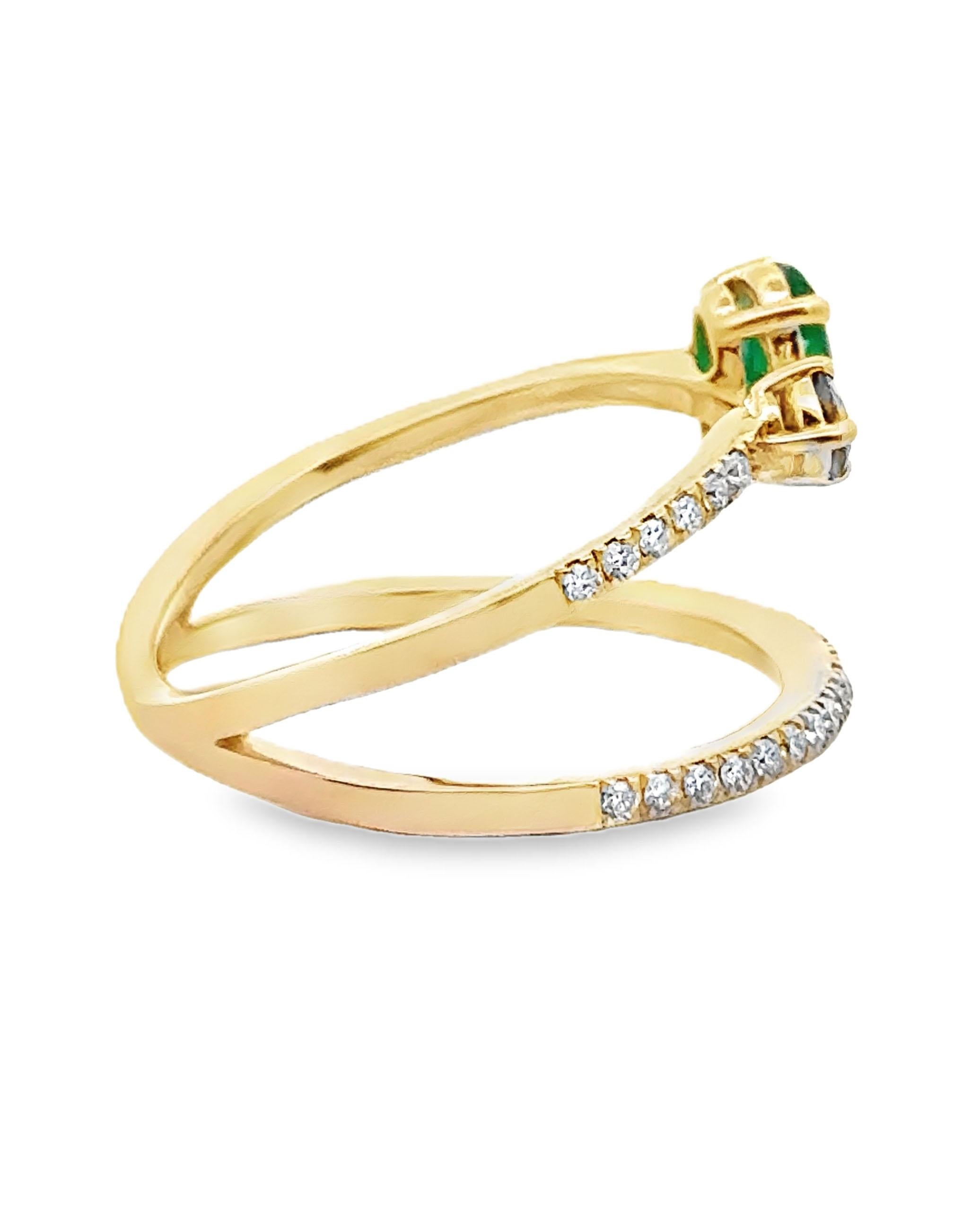 14K yellow gold fashion ring with one round faceted sapphire weighing 0.13 carats, one oval shape emerald weighing 0.65 carats, and 45 round faceted diamonds weighing 0.23 carats total.   

- Finger size 7