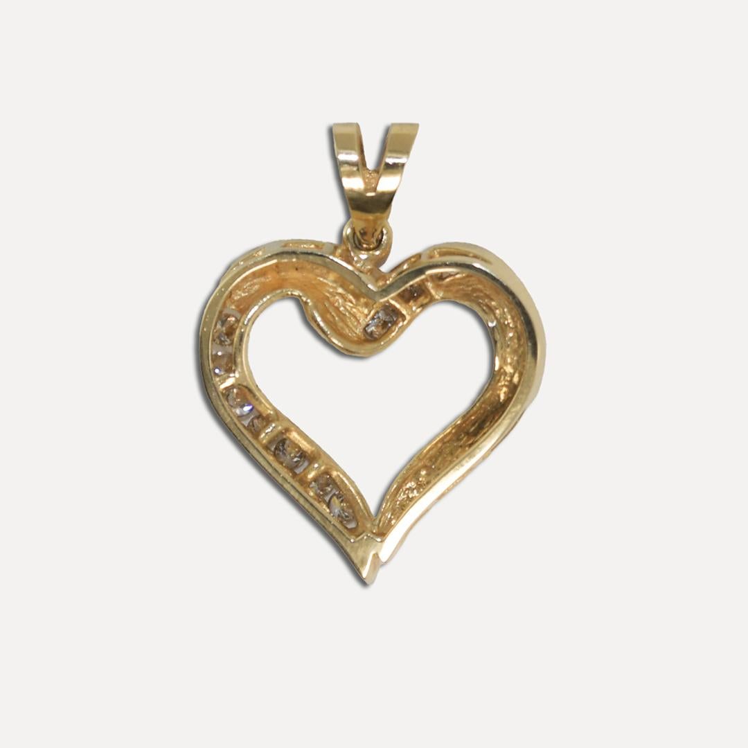 14k yellow gold diamond heart pendant.
Tests 57.5% gold with an XRF metals analyzer.
The gross pendant weight is 3.7 grams.
The diamonds are round brilliant cuts, .30 total carats, j to k color, and Si clarity.
The pendant measures 1 inch long with