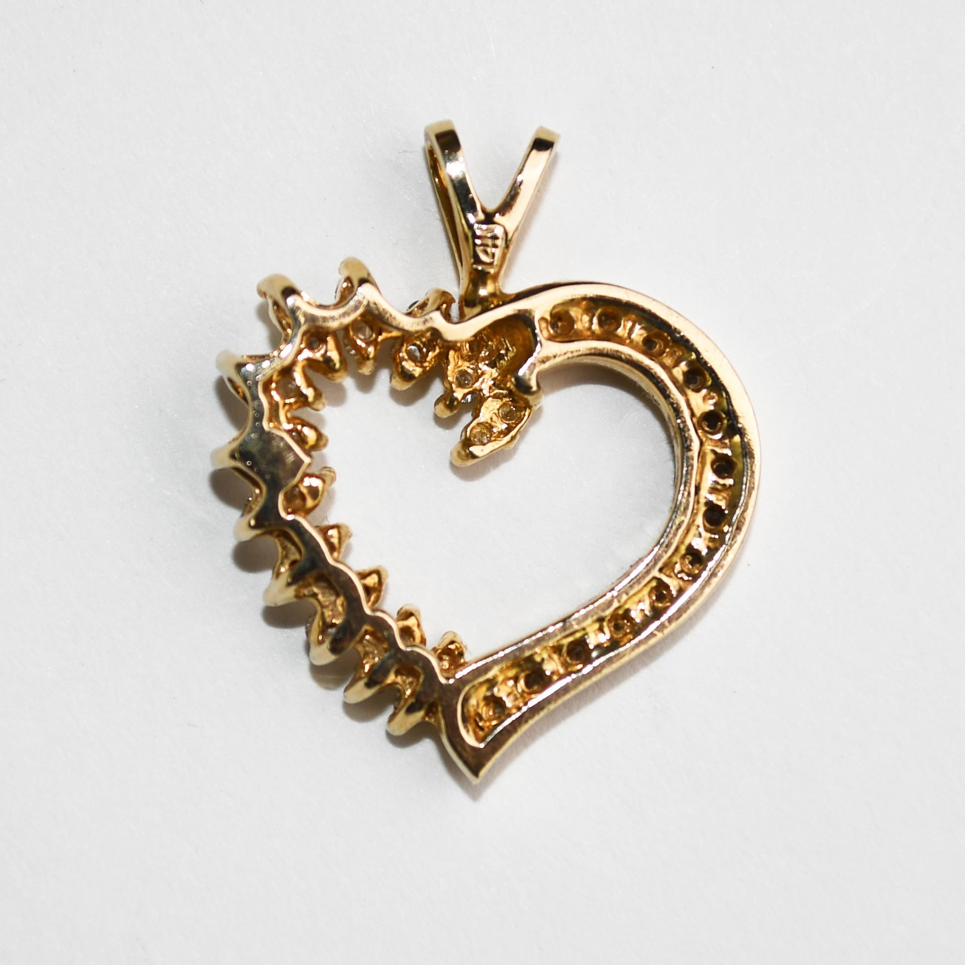 Diamond heart pendant in 14k yellow gold.
Stamped 14k and weighs 6.2 grams.
Round brilliant cut diamonds, .50 total carats, H color, Si clarity.
Measures 3/4 by 3/4 inches.
Excellent condition.
