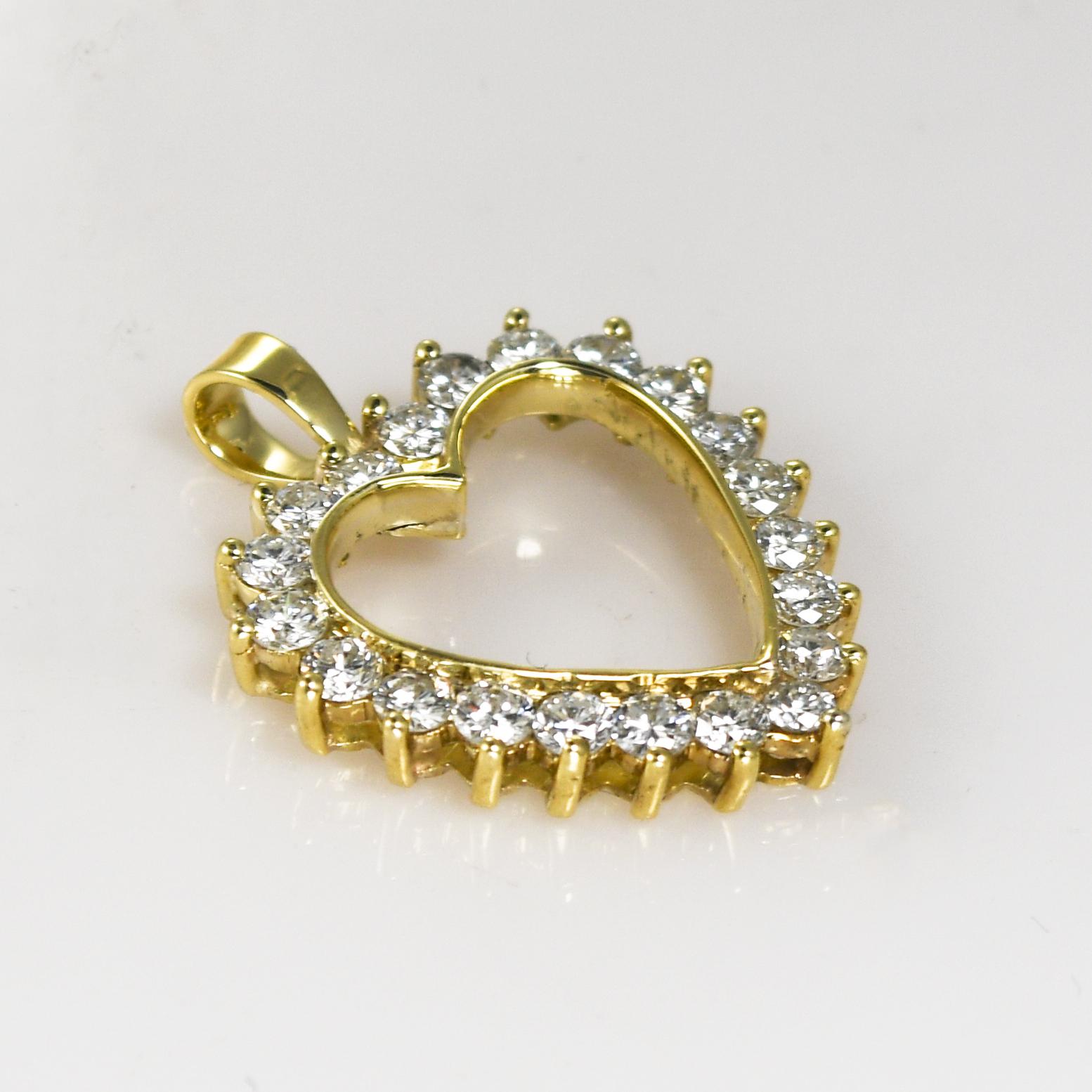 14k yellow gold and diamond heart pendant.
The gold tests 14k using an electronic tester.
Pendant weight is 3.5 grams.
The diamonds are round brilliant cuts, 1.00 total carats, G to H color, Vs clarity.
The pendant measures 1 inch long by 3/4 inches