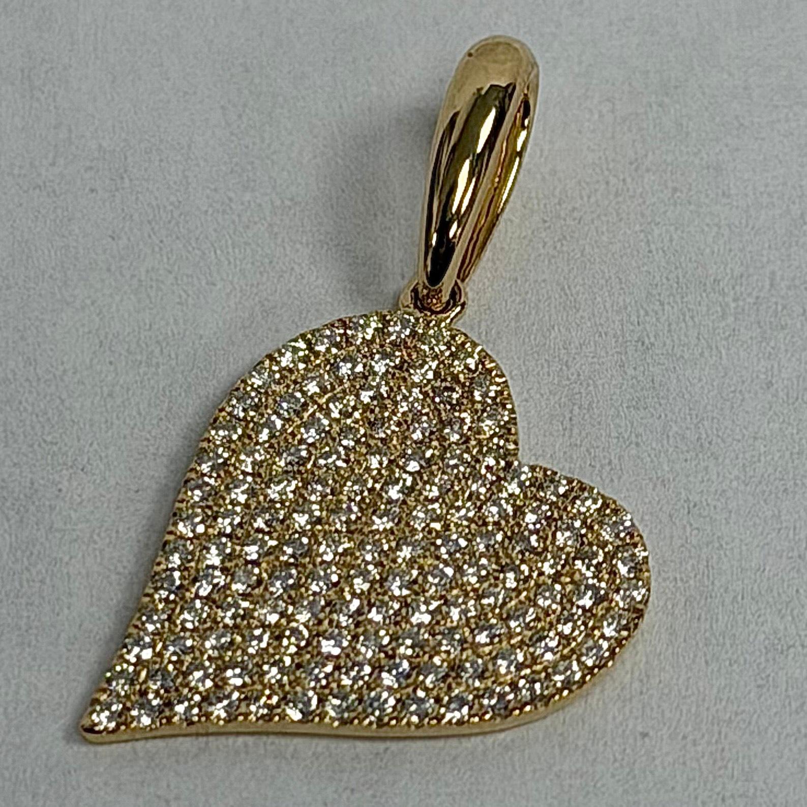 This 14K Yellow Gold Diamond Heart Pendant is a bright and beautiful piece that brings a touch of sparkle to any look. Made from 1.6 grams of solid yellow gold, it feels light and easy to wear every day. The heart design is covered with 132 round