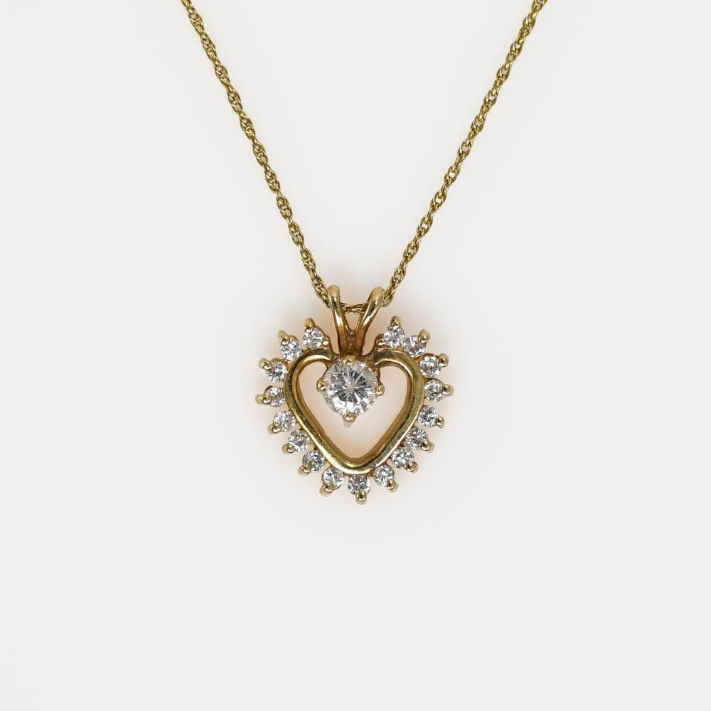 14k Yellow Gold Diamond Pendant.
There is .35tdw of Round Brilliant Cut Diamonds.
Clarity SI1-I1, Color G-H-I.
The chain attached is a thin rope style, 19in, stamped 14k on the clasp.
Total weight is 2.6gr.