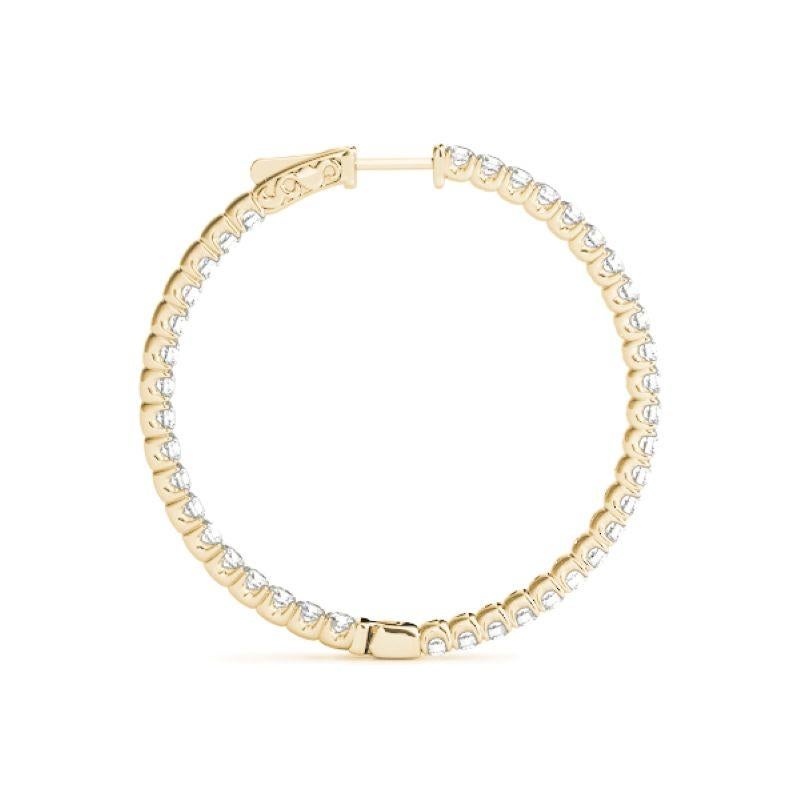 Handcrafted in New York, these 14K yellow gold diamond hoop earrings offer a bold yet timeless design. Each 36mm (1.5-inch) hoop showcases a continuous row of round brilliant-cut diamonds in a secure 4-prong setting—designed to sparkle from every