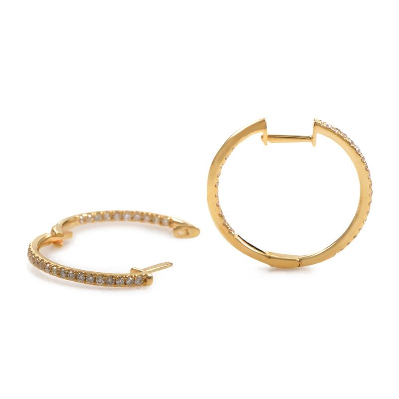 These impressively designed hoop earrings are beautifully crafted from 14K yellow gold and feature 0.51ct of brilliant-cut diamond stones, set on frontally visible sides both on the outside and the inside of the hoops.
