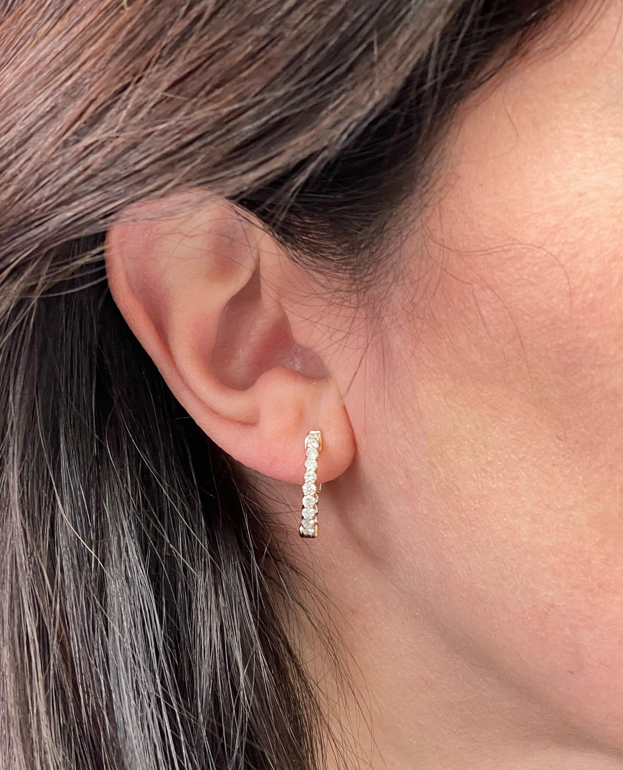 14K yellow gold hoop earrings with round brilliant-cut diamonds weighing 0.83 carat total.  

- Earrings are 18 millimeters in diameter
- Diamonds are G/H color, SI clarity