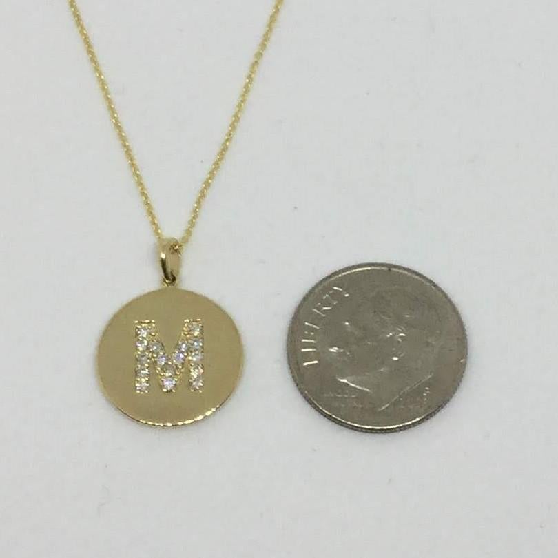 14K Yellow gold diamond initial pendant necklace. The diamonds are common prong set. The disc is just iver a half an inch in diameter. The chain is 18 inches in length.

Other available letters are A, B, E, J, K, L, R and S.
